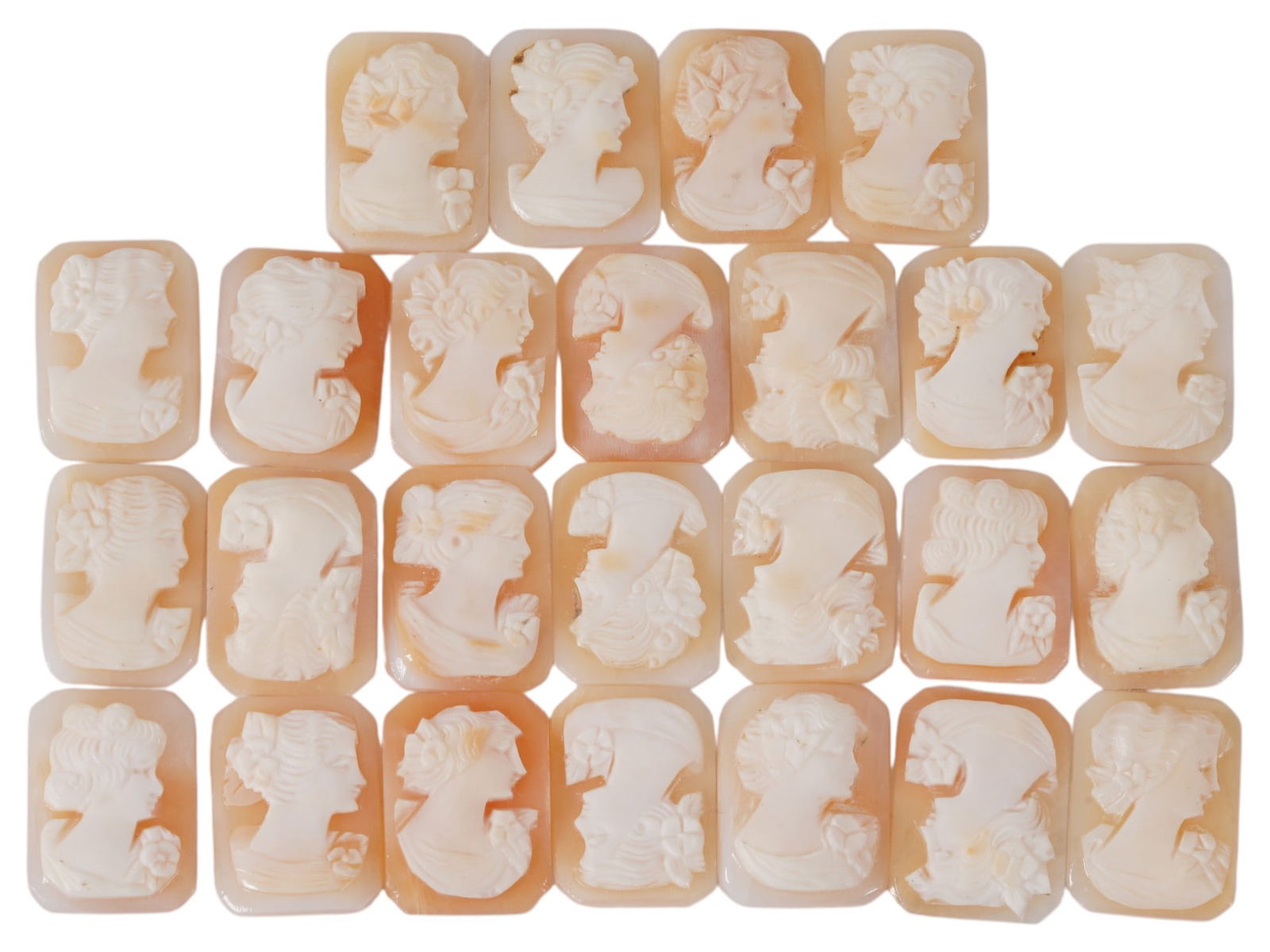 COLLECTION OF CARVED FEMALE PORTRAIT SHELL CAMEOS: A collection of hand carved shell cameos. A total of 25 items. Each piece depicts a female profile portrait rendered in high relief in the Victorian manner. Each cameo is fashioned in a distinctive oc