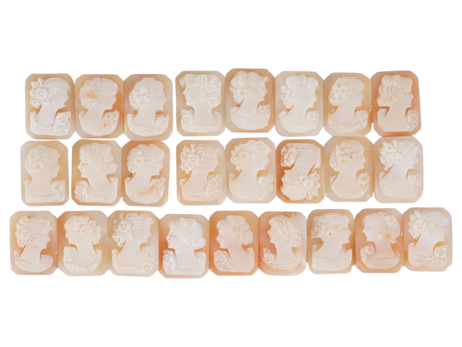 COLLECTION OF CARVED SHELL CAMEOS WITH FEMALE PORTRAITS: A collection of 25 carved shell cameos featuring high-relief female portraits, executed in a traditional classical style associated with Victorian-era jewelry. The loose unmounted pieces display detai