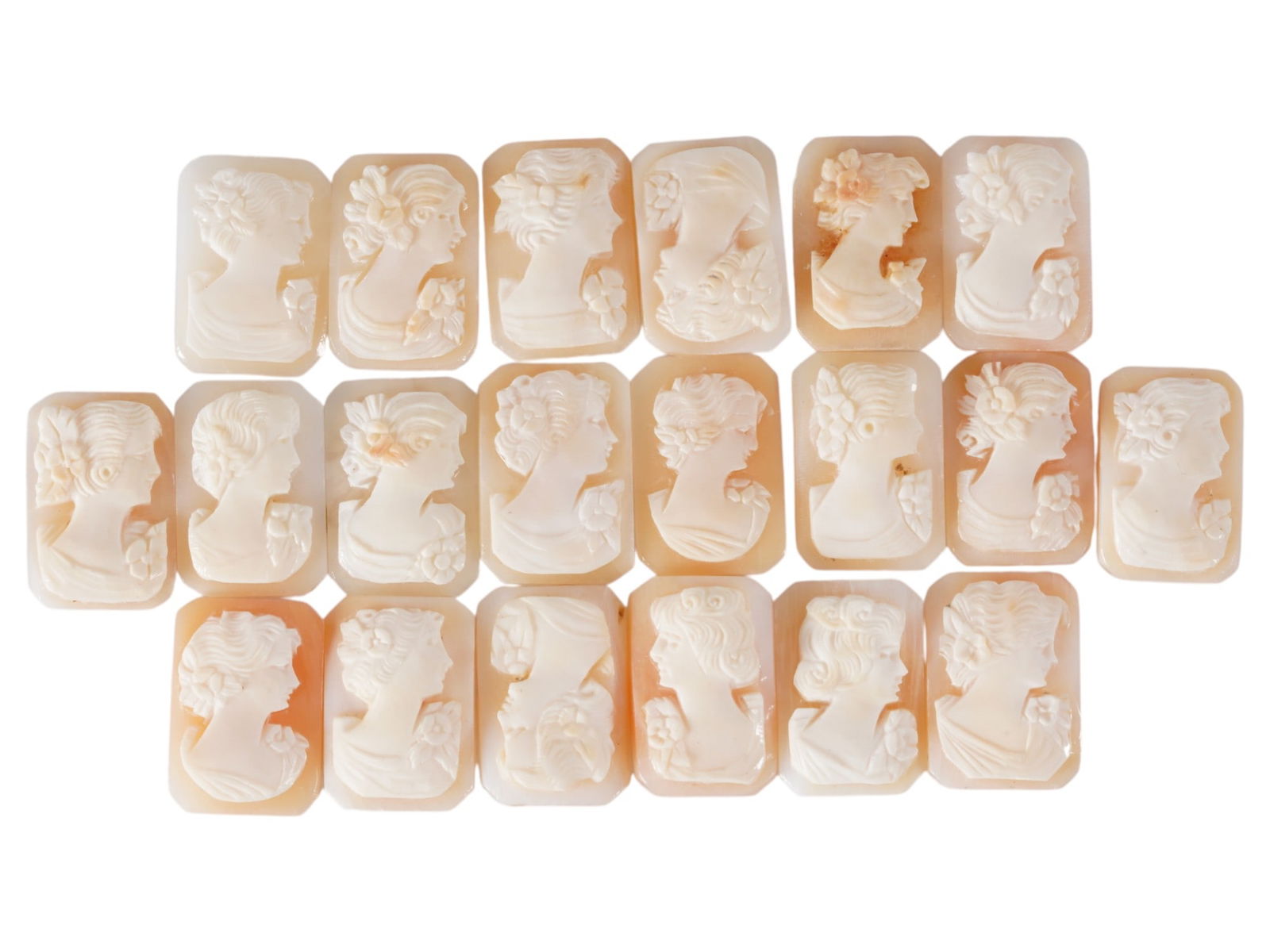 COLLECTION OF CARVED SHELL CAMEOS WITH FEMALE PORTRAITS: A collection of 20 carved shell cameos featuring high-relief female portraits, executed in a traditional classical style associated with Victorian-era jewelry. The loose unmounted pieces display detai