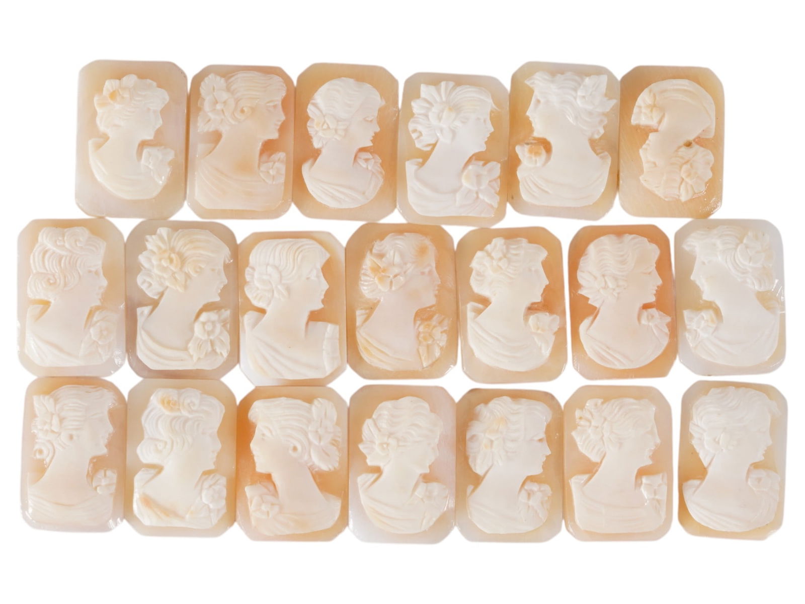 COLLECTION OF CARVED SHELL CAMEOS WITH FEMALE PORTRAITS: A collection of 20 carved shell cameos featuring high-relief female portraits, executed in a traditional classical style associated with Victorian-era jewelry. The loose unmounted pieces display detai
