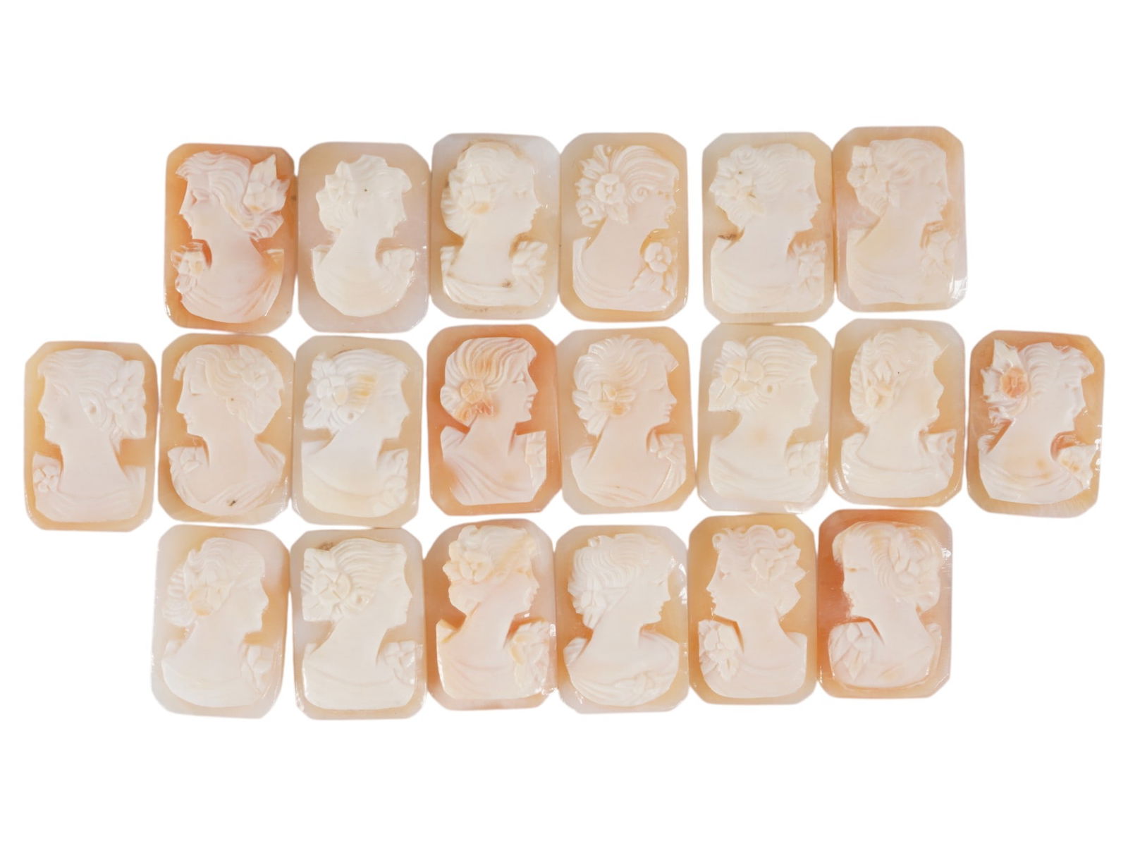 COLLECTION OF CARVED SHELL CAMEOS WITH FEMALE PORTRAITS: A collection of 20 carved shell cameos featuring high-relief female portraits, executed in a traditional classical style associated with Victorian-era jewelry. The loose unmounted pieces display detai