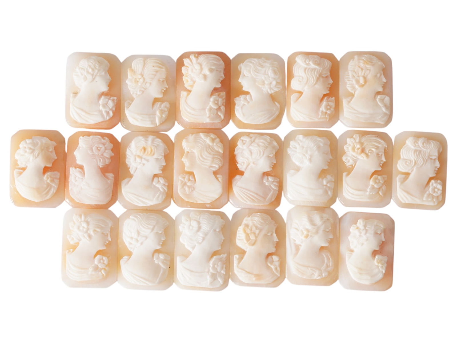 COLLECTION OF CARVED SHELL CAMEOS WITH FEMALE PORTRAITS: A collection of 20 carved shell cameos featuring high-relief female portraits, executed in a traditional classical style associated with Victorian-era jewelry. The loose unmounted pieces display detai