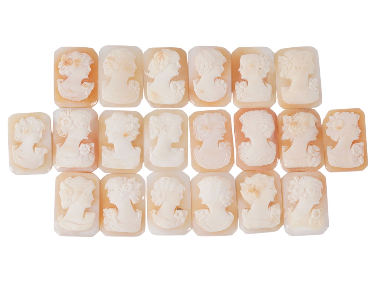 COLLECTION OF FEMALE PORTRAIT CARVED SHELL CAMEOS: A collection of hand carved shell cameos. A total of 20 items. Each piece depicts a female profile portrait rendered in high relief in the Victorian manner. Each cameo is fashioned in a distinctive oc