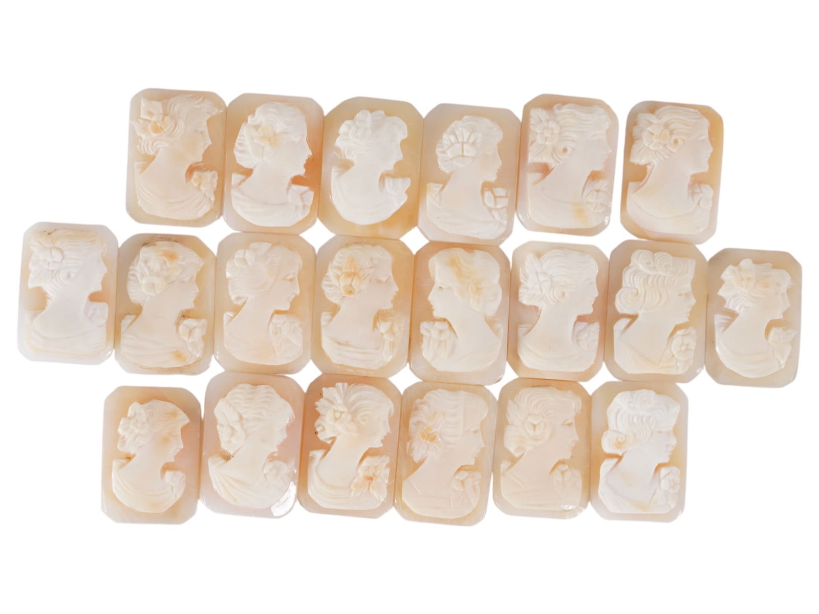 COLLECTION OF FEMALE PORTRAIT CARVED SHELL CAMEOS: A collection of hand carved shell cameos. A total of 20 items. Each piece depicts a female profile portrait rendered in high relief in the Victorian manner. Each cameo is fashioned in a distinctive oc