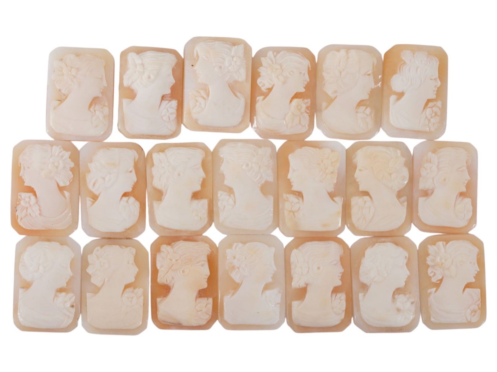 COLLECTION OF FEMALE PORTRAIT CARVED SHELL CAMEOS: A collection of hand carved shell cameos. A total of 20 items. Each piece depicts a female profile portrait rendered in high relief in the Victorian manner. Each cameo is fashioned in a distinctive oc