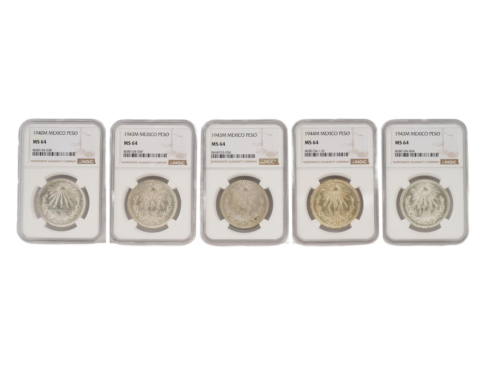 GRADED NGC MEXICAN 1 PESO SILVER COINS 1940S: A lot of five Mexican 1 peso silver coins of the 1940s professionally graded and encapsulated by the NGC Guaranty Company. The obverse features the Mexican coat of arms: a golden eagle perched on a pr