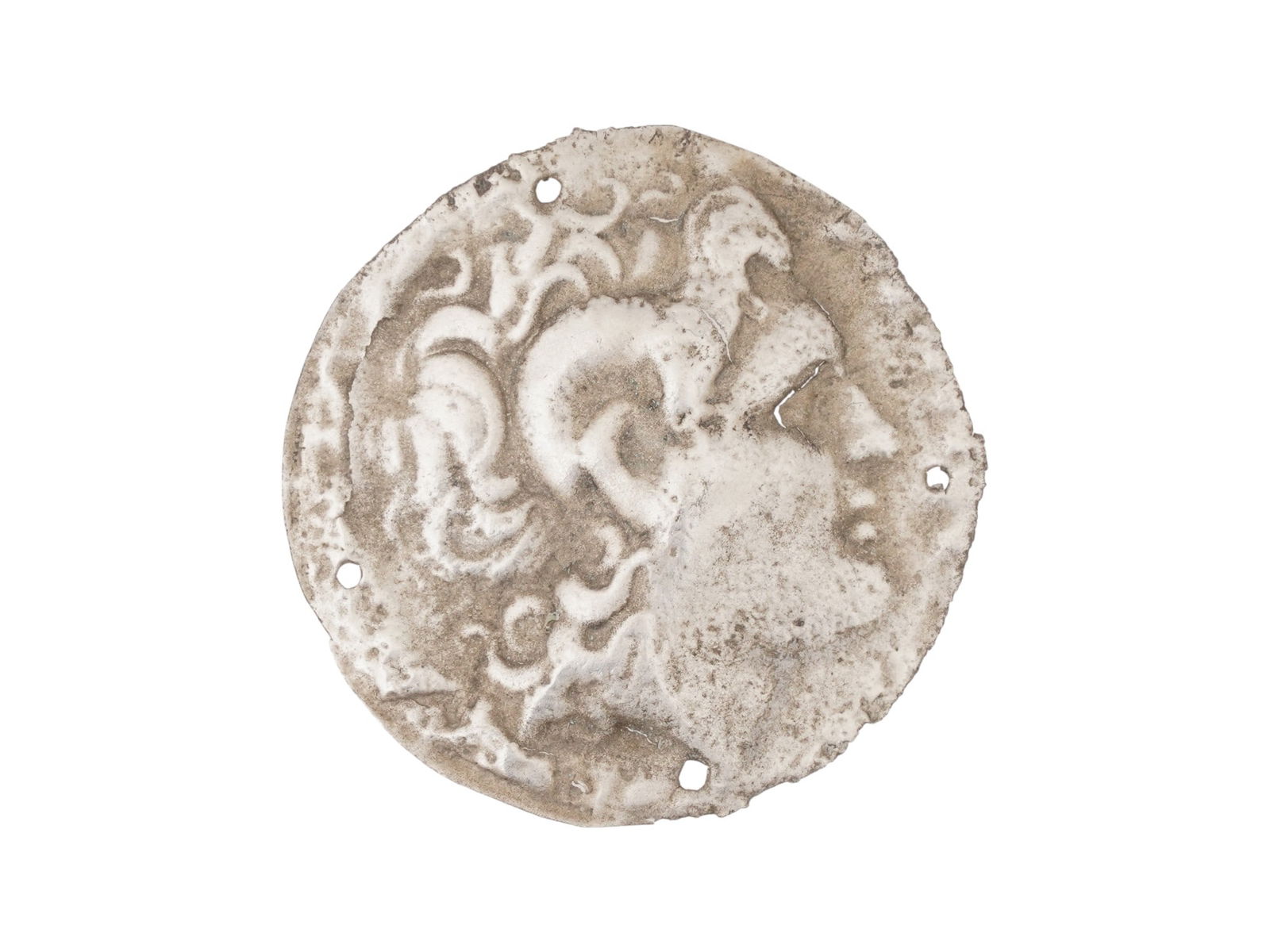 ANCIENT GREEK SILVER PLAQUE W PROFILE 400 TO 300 BC: An ancient Greek silver repousse plaque, circa 400 to 300 BC. The plaque features a right-facing profile, presumably the god or a leader. The small holes around the perimeter suggest it was intended t