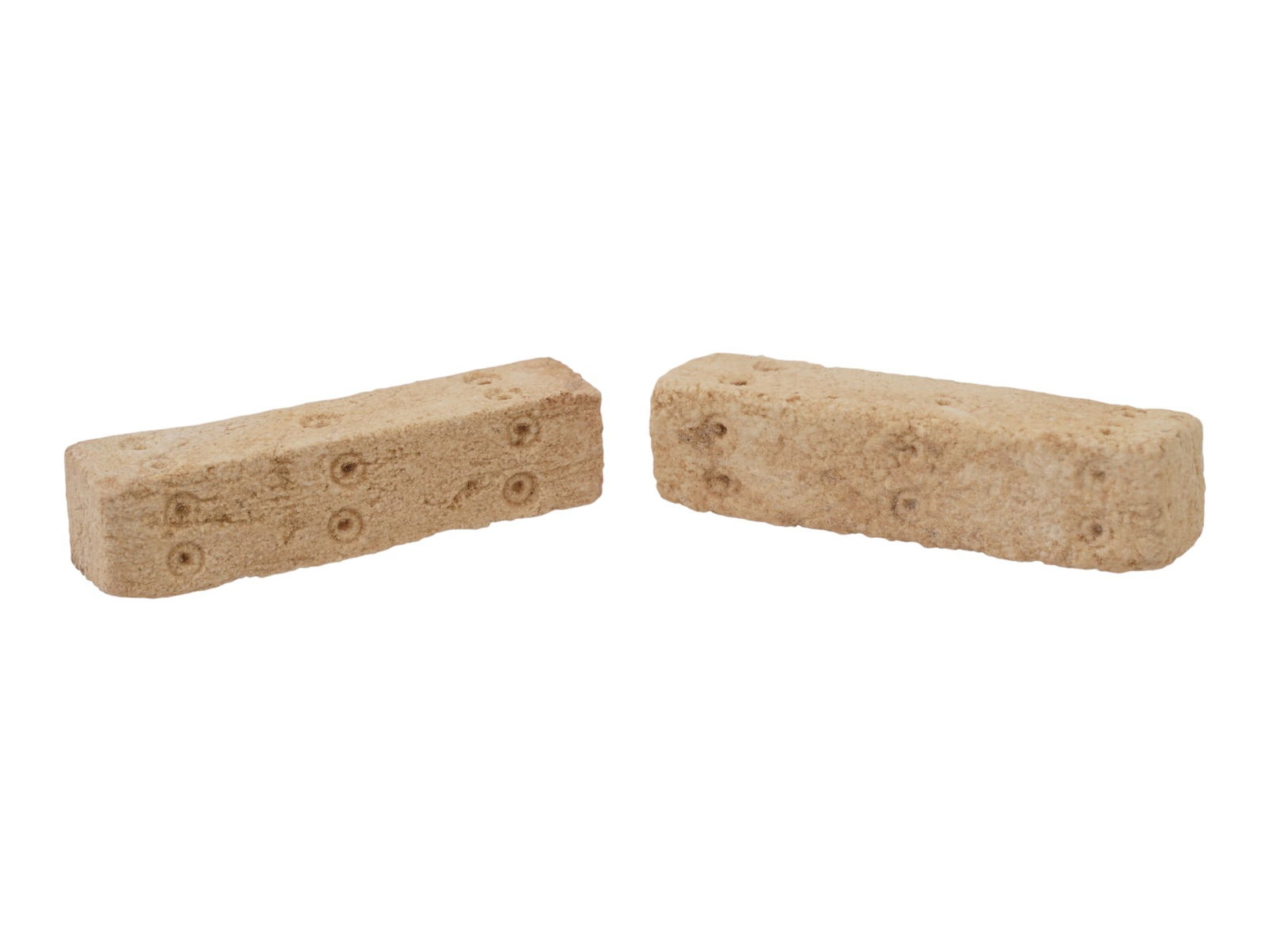 PAIR OF ANCIENT ROMAN ELONGATED STONE DICE 100 TO 300 AD: A pair of ancient Roman hand carved elongated stone dice, circa 100 to 300 AD. Carved from stone featuring an elongated design, these dice evoke the excitement and anticipation of games played by Roma