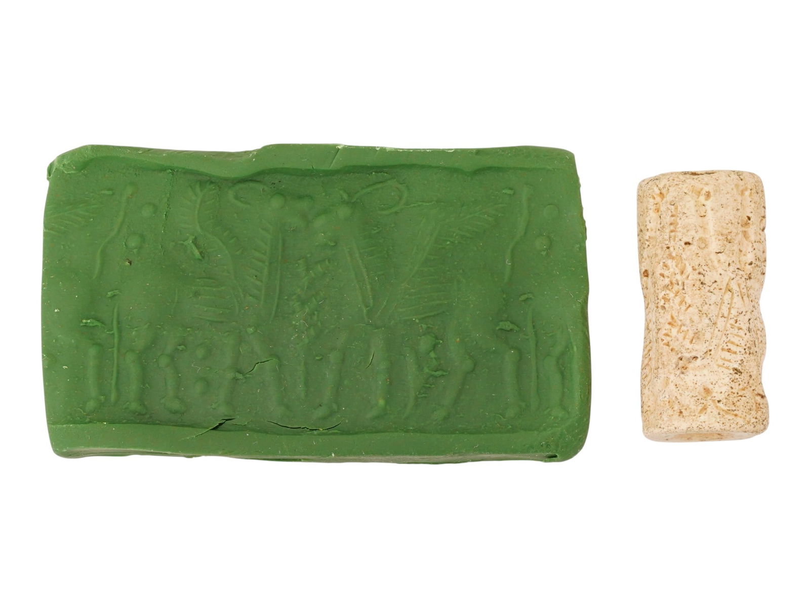 ANCIENT NEAR EASTERN CARVED STONE CYLINDER SEAL: An ancient Near Eastern carved stone cylinder seal dating to the 1st millennium BC, engraved with a ritual scene characteristic of Mesopotamian glyptic art. Such seals were used as personal identifier