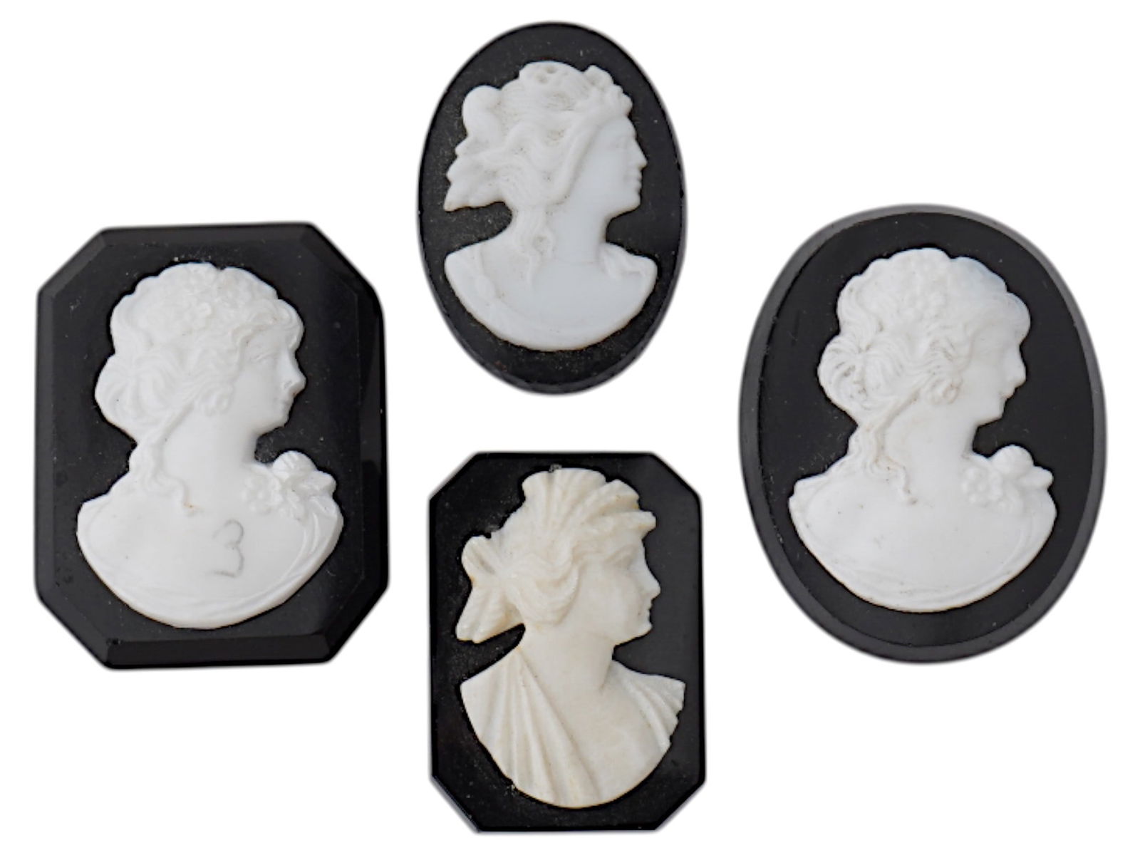 COLLECTION OF FEMALE PORTRAIT ONYX SHELL CAMEOS: A collection of four vintage cameos in various shapes. Each cameo with an oval or octagonal cut onyx panel with applied carved shell depicting a portrait of a lady in profile in the Victorian manner.