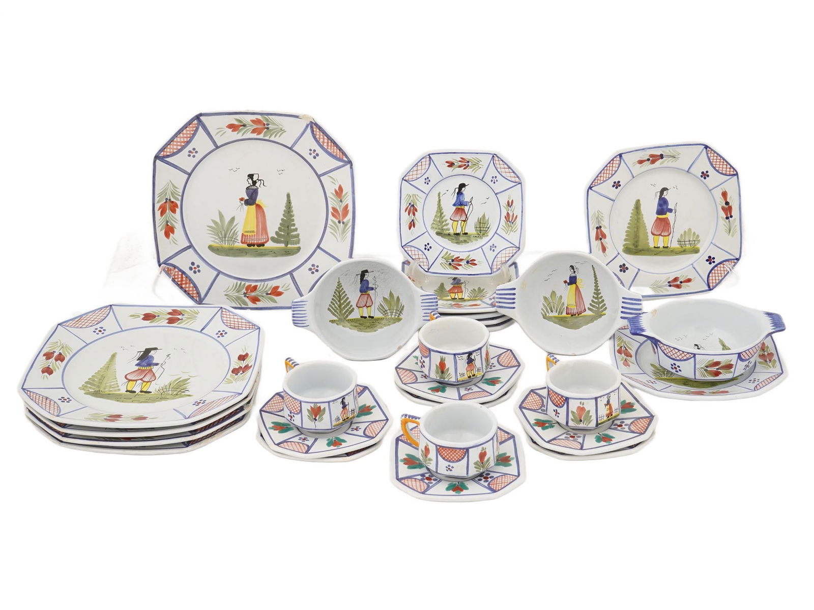 VINTAGE SET OF FRENCH QUIMPER CERAMIC WARES: A vintage set of Quimper ceramic wares, includes teacups, saucers, plates and handled dishes. A classic example of French faience, handcrafted in the town of Quimper, Brittany. This style is famous