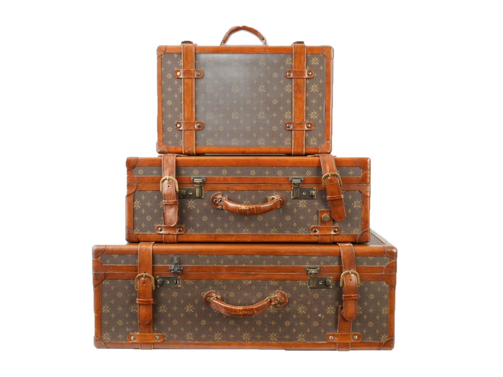 GROUP OF THREE VINTAGE LOUIS VUITTON STYLE STORAGE CASES: A group of three vintage Louis Vuitton style storage cases. The pattern on these cases is a repetitive emblem motif that mimics the iconic Louis Vuitton Monogram. This specific set is designed for