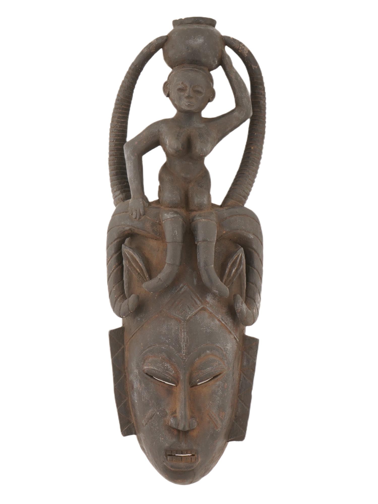 WEST AFRICAN BAULE PEOPLE WOOD MASK FROM IVORY COAST: A West African Baule people hand carved wooden mask from Ivory Coast. The Baule people are known for their intricate and expressive masks, which are often used in traditional ceremonies and rituals. T