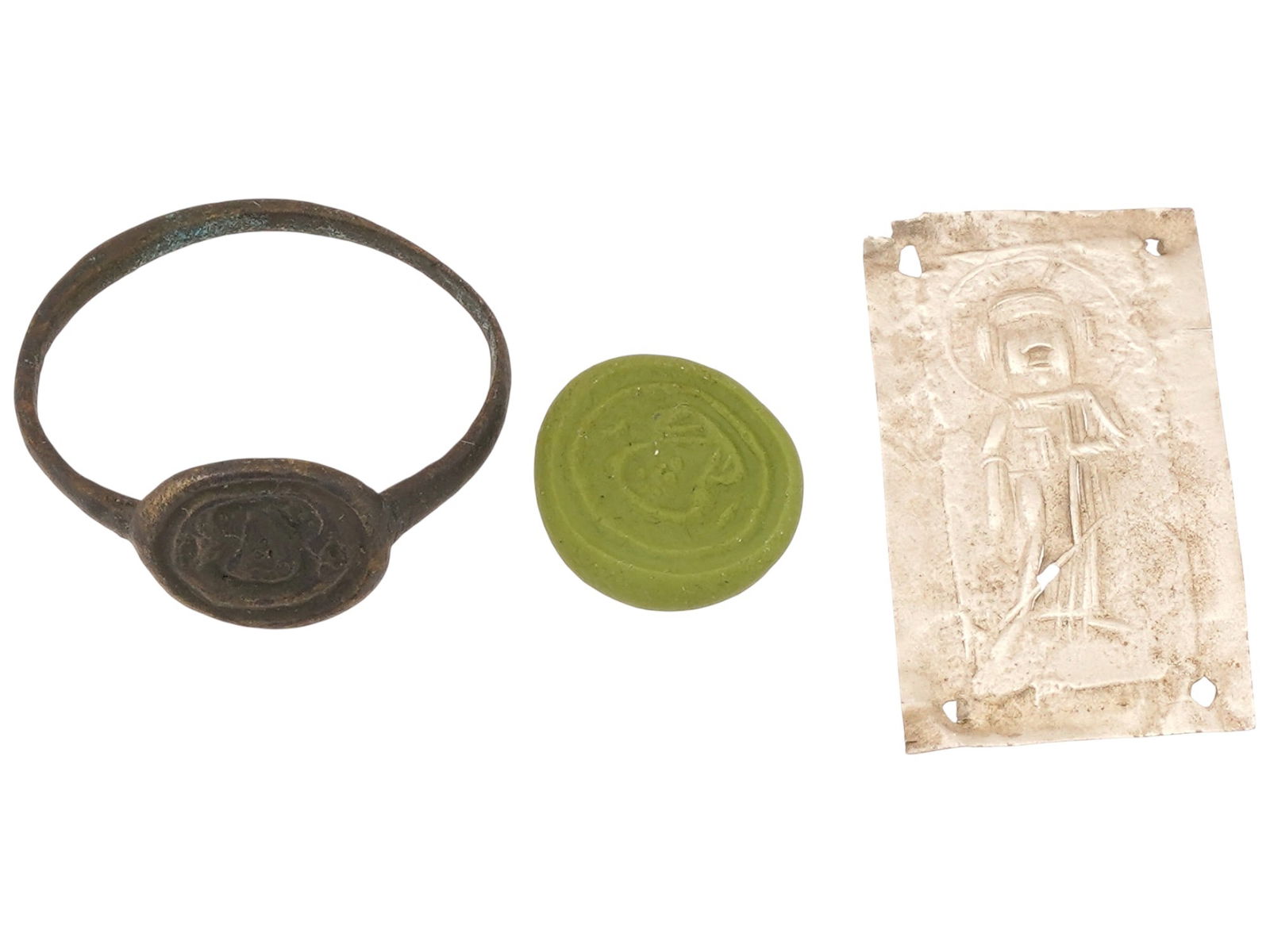 ANCIENT BYZANTINE JESUS CHRIST RING AND SILVER PLAQUE: An ancient Byzantine Empire bronze ring decorated with an engraved image of Jesus Christ on the flat, round top. Circa 300 A.D. to 600 A.D. And an ancient Byzantine Empire silver plaque, dating from 3