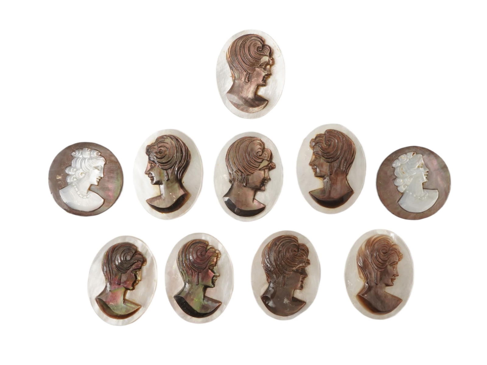 COLLECTION OF FEMALE PORTRAIT CARVED SHELL CAMEOS: A collection of hand carved conch chell cameos. A total of 10 items. Each piece is crafted from conch shell, featuring female profile portraits rendered in high relief. Oval and round shapes. Collecti