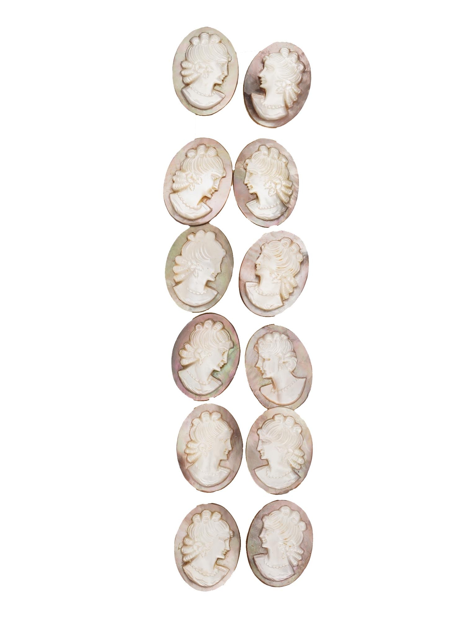 COLLECTION OF ANTIQUE HAND CARVED CAMEOS: A collection of 12 antique hand-carved cameos, dating to the early 20th century, each crafted from conch shell in the traditional oval form. The cameos depict female profile portraits in high relief,