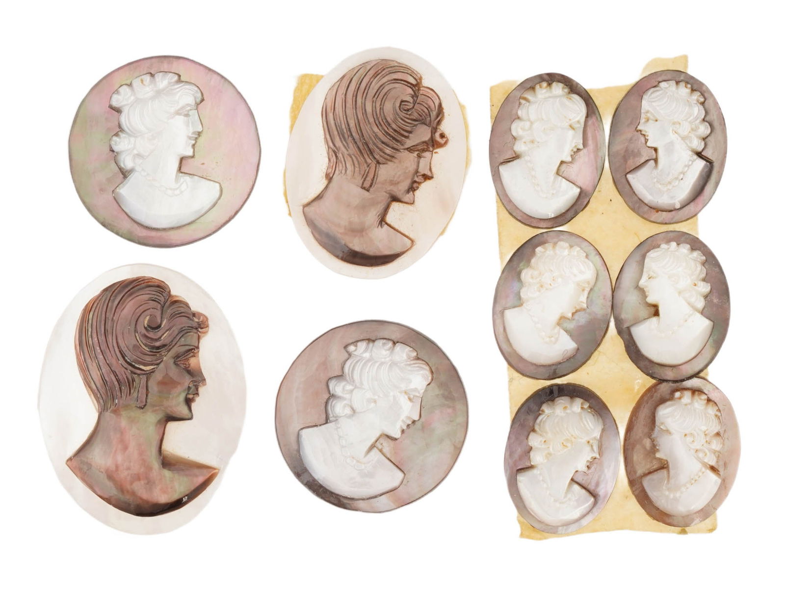 COLLECTION OF ANTIQUE OVAL HAND CARVED SHELL CAMEOS: A collection of 10 antique hand-carved cameos, dating to the early 20th century, each crafted from conch shell in the traditional oval form. The cameos depict female profile portraits in high relief,
