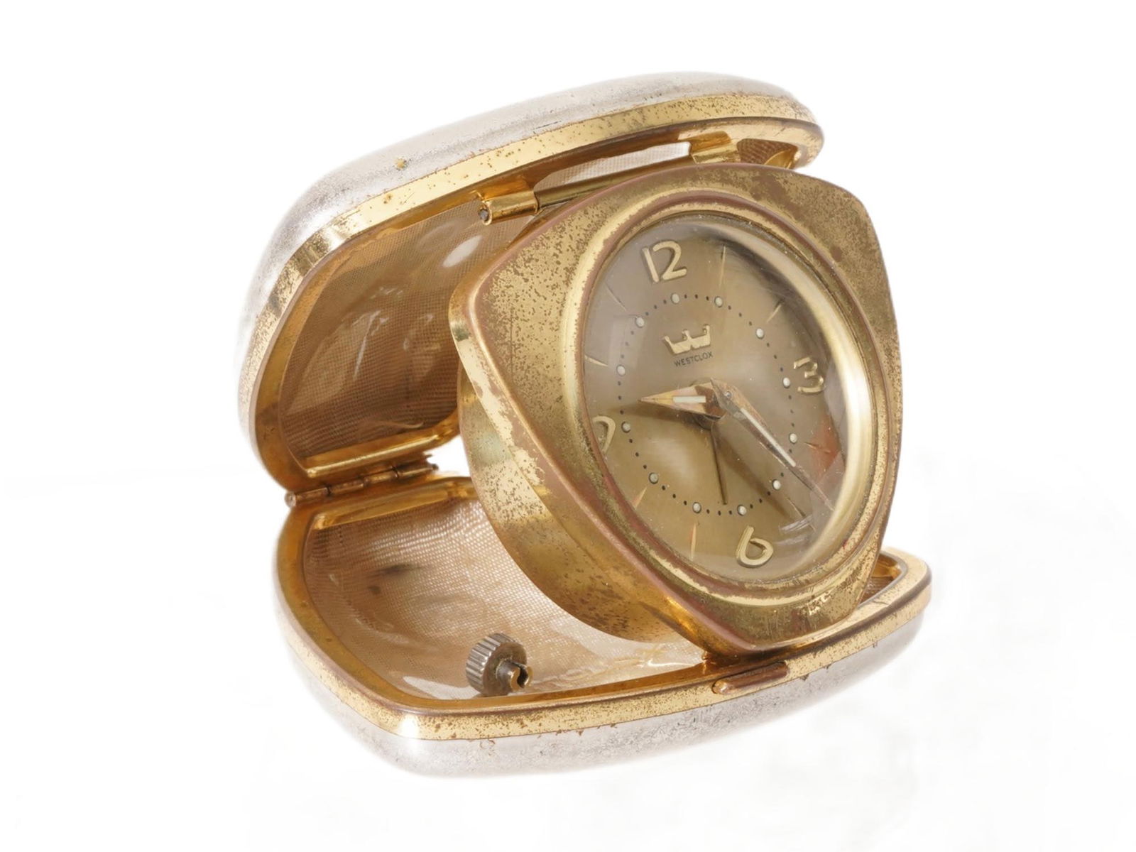 SMALL VINTAGE AMERICAN WESTCLOX TRAVEL ALARM CLOCK: A small vintage American mid-century Westclox travel alarm clock. The clock features a folding case shaped like a soft triangle. The round dial features Westclox logo and numerals at 12, 3, 6, and 9.