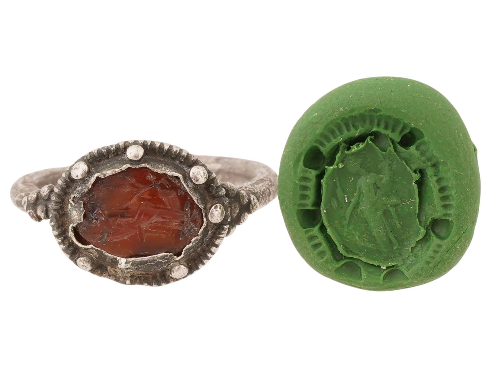 ANCIENT ROMAN SILVER RING W ENGRAVED CARNELIAN INTAGLIO: An ancient Roman silver ring featuring a hand-carved carnelian intaglio, dating to approximately 100 to 300 AD. The intaglio is engraved with a standing goddess Fortuna. The oval carnelian is set into