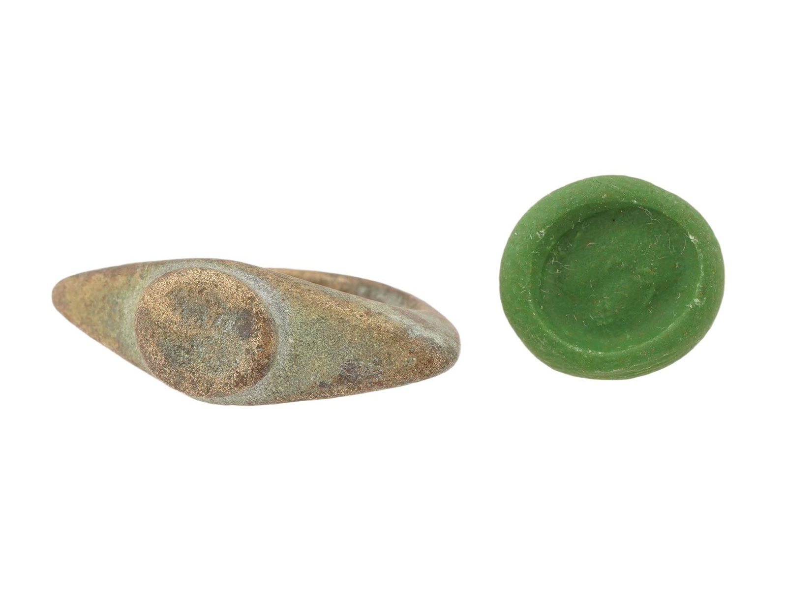 ANCIENT ROMAN ENGRAVED BRONZE RING 100 TO 300 AD: An ancient Roman engraved bronze signet ring. The ring features a flat oval bezel with an engraved image of a head. Circa: 100 to 300 AD. Archaeological and Historical Wares, Bronze Jewelry Wares and