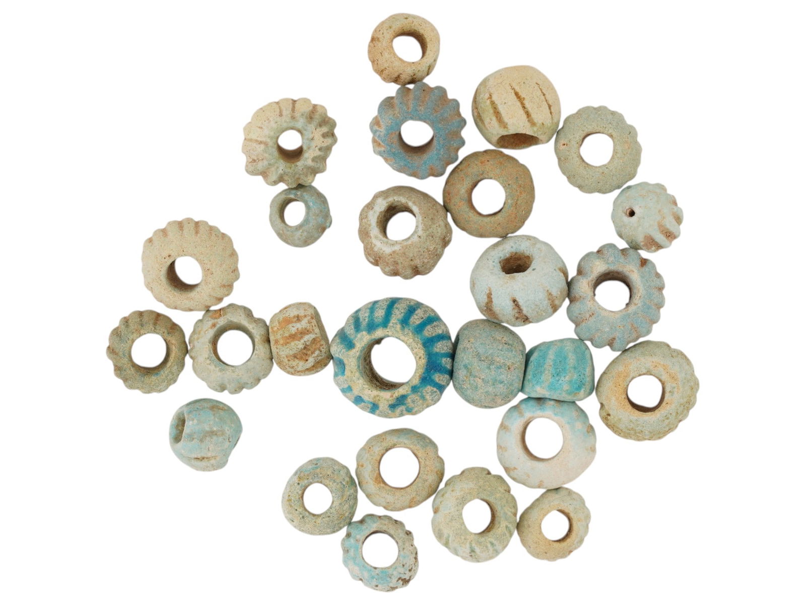ANCIENT EGYPTIAN FAIENCE BEADS LATE PERIOD 500 TO 200 BC: A large collection of assorted ancient late period Egyptian beads made of faience. Late Period or Roman Egypt, ca. 500 to 200 BC. The beads are presented in a circular shape featuring a ribbed design
