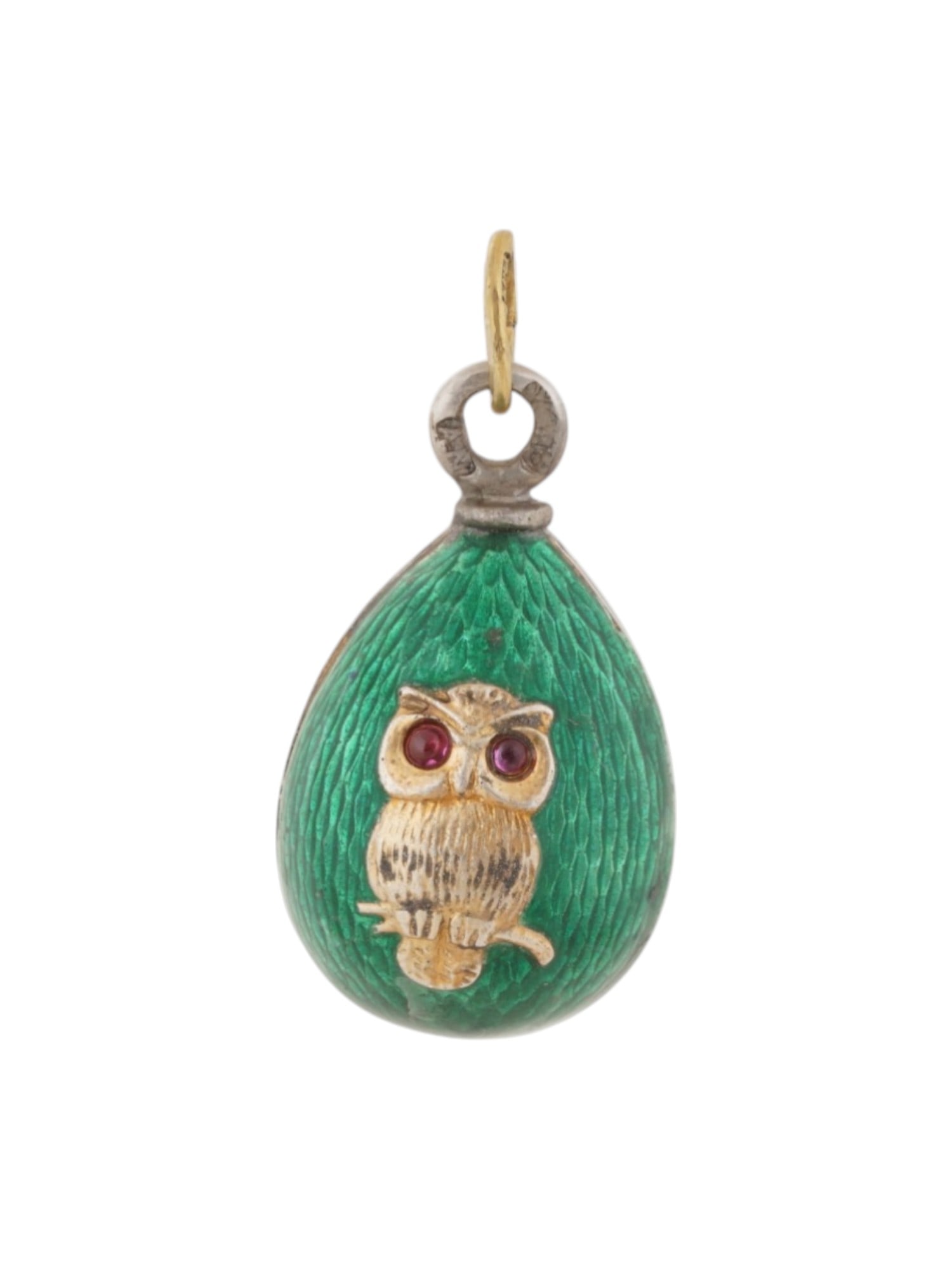 RUSSIAN SILVER ENAMEL EASTER EGG PENDANT WITH RUBIES: A Russian silver pendant designed in the form of an Easter egg and decorated with vibrant green guilloche enamel. The pendant features an owl motif, often interpreted as a wise owl charm, with ruby ey