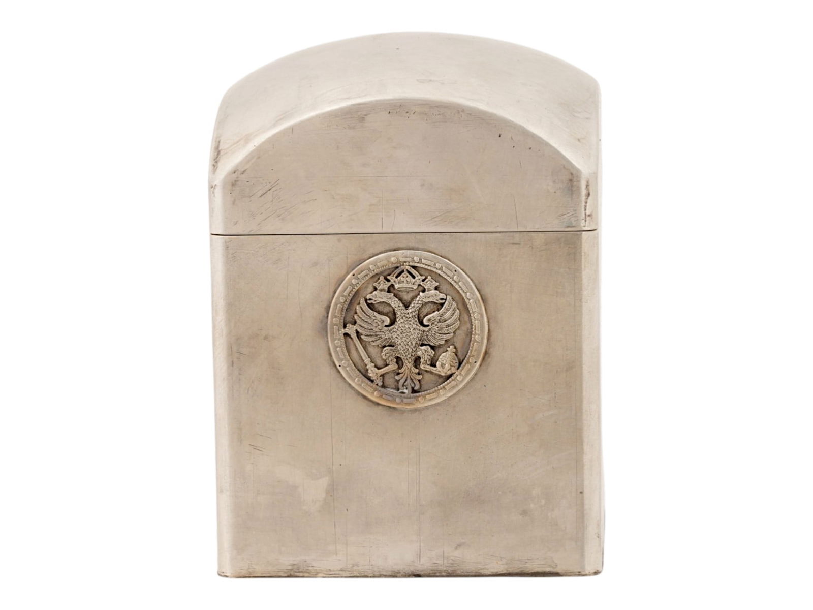 RUSSIAN SILVER IMPERIAL PRESENTATION TEA CADDY: A Russian silver presentation tea caddy of a rectangular form with a matched domed cover. The body of the item is adorned with a silver overlay depicting a Russian Imperial warrant. Features a gold