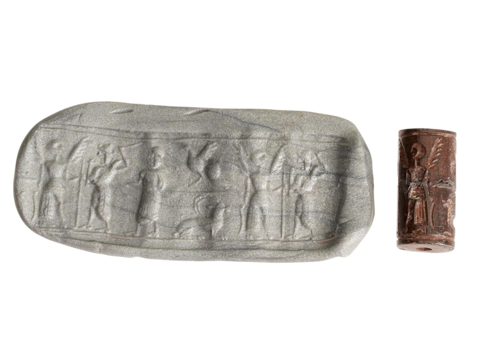 ANCIENT WESTERN ASIATIC HEMATITE BEAD W RITUAL IMAGES: An ancient Western Asiatic hematite bead, dating to the 1st millennium BC. Engraved with ritual imagery characteristic of Near Eastern glyptic art. Carved from dark, lustrous hematite, the bead featur