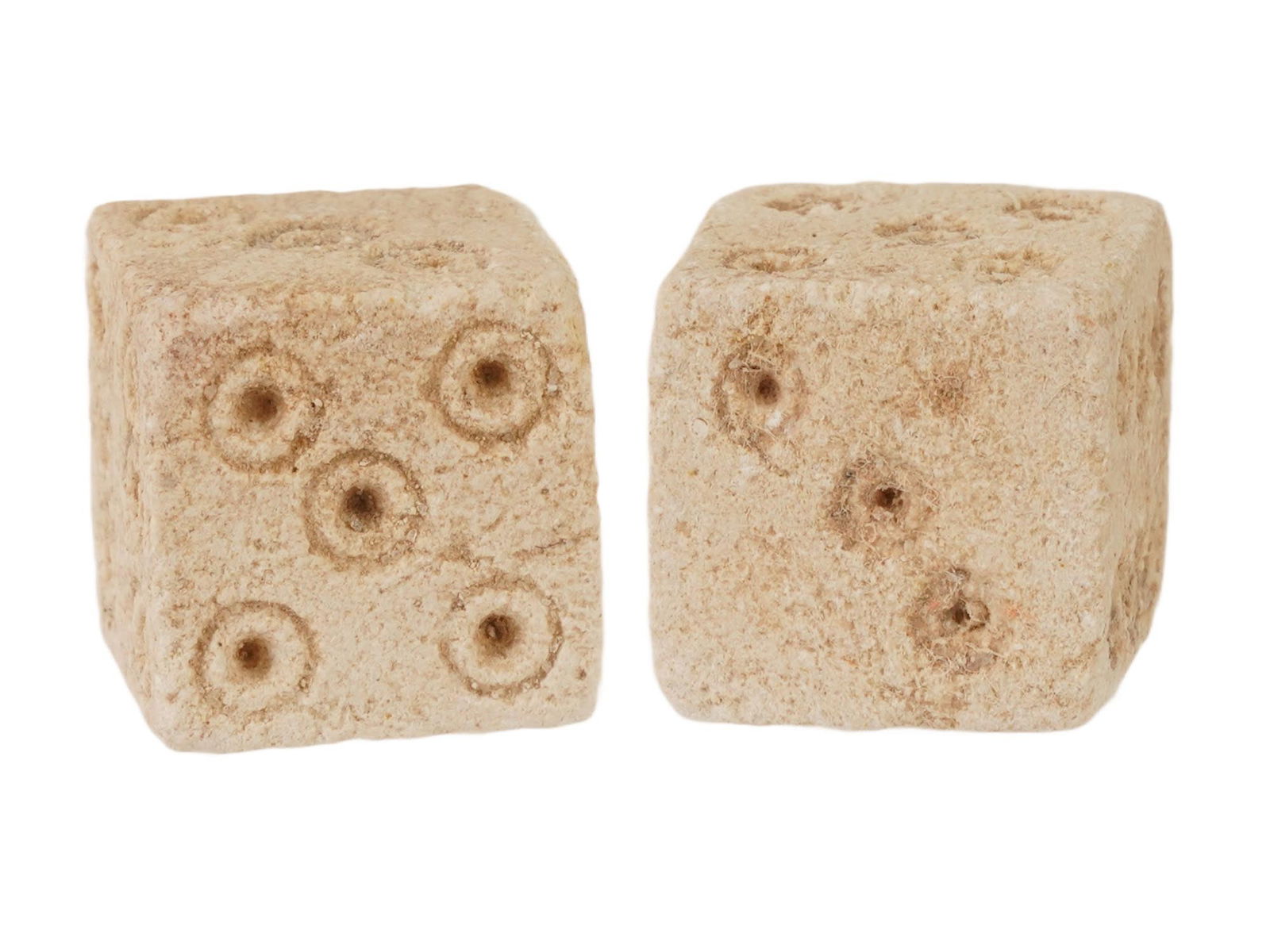 PAIR OF ANCIENT ROMAN STONE DICE 100 TO 300 AD: A pair of ancient Roman hand carved stone dice, dating from 100 to 300 AD. These artifacts offer a tangible connection to the everyday life and leisure activities of the past. Carved from stone featur