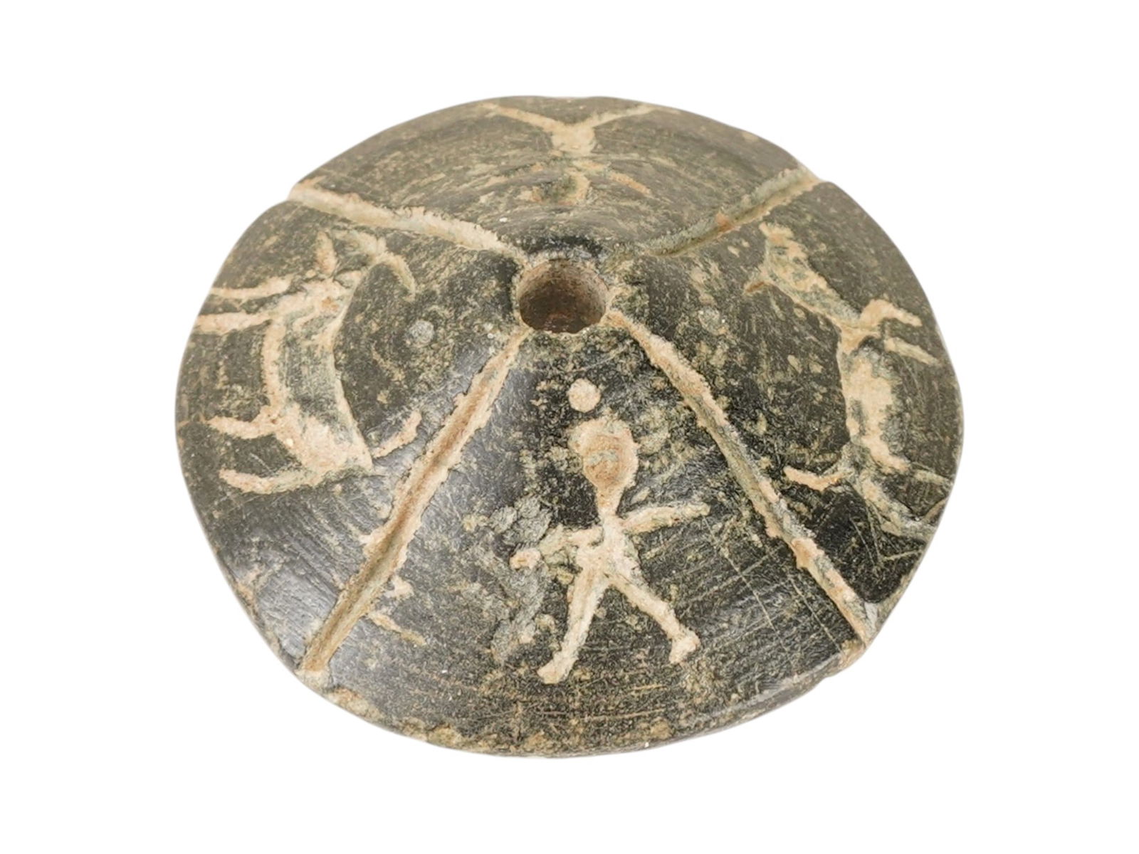 ANCIENT HELLENISTIC CARVED STEATITE SPINDLE WHORL: An ancient Hellenistic carved steatite stone spindle whorl. Circa: 300 to 100 BC. The ware has a round shape and intricate carvings featuring human and zoomorphic motifs. There is a through hole in th