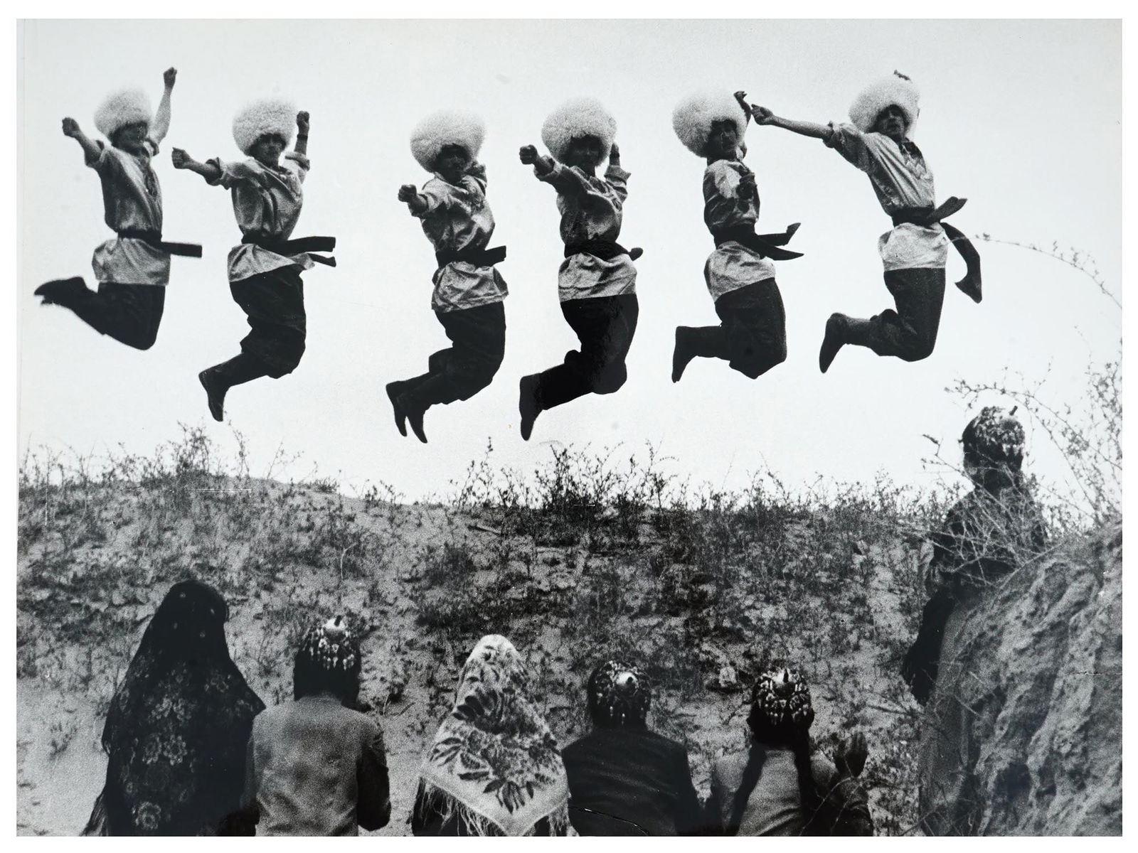 RUSSIAN SOVIET ERA PHOTOGRAPH BY GEORGY ZELMA: A black-and-white photograph by Georgy Zelma, 1906 to 1984, a Soviet photographer and photojournalist. The piece depicts six Caucasian men in traditional attire dancing lezginka. Artists stamp and pen