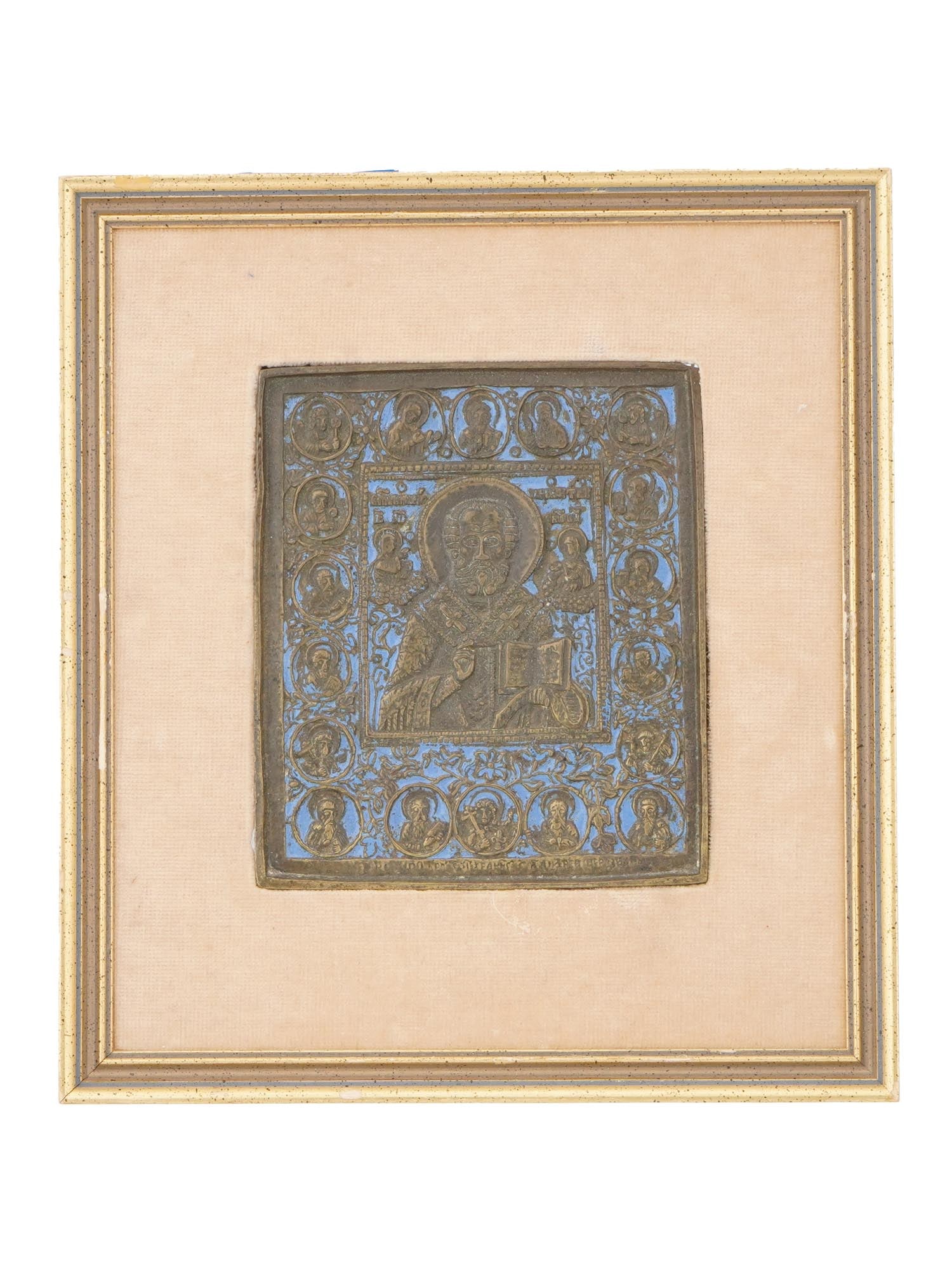 ANTIQUE RUSSIAN BRONZE ENAMEL ICON ST. NICHOLAS OF MYRA: An antique Russian Orthodox icon of St. Nicholas of Myra, cast in brass with blue enamel. The central figure of St. Nicholas is framed by eighteen smaller depictions of saints, detailed in relief. Dat
