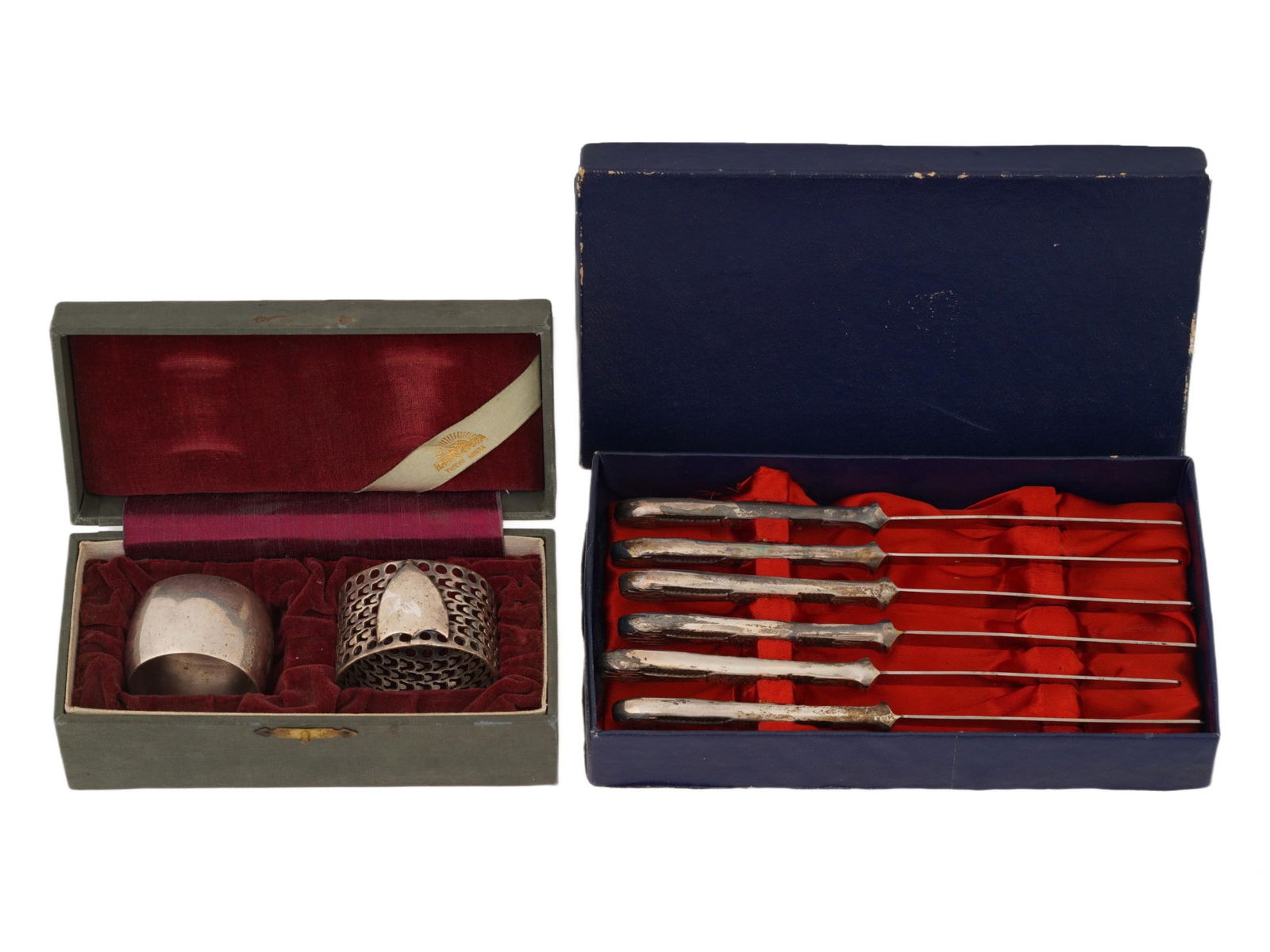 LOT OF SILVER KNIVES AND NAPKIN HOLDERS IN BOXES: A collection of assorted low silver serving pieces. The collection includes two napkin holders: a smooth ring engraved with the name Caroline in cursive and marked, E.P.N.S; and a Victorian manner