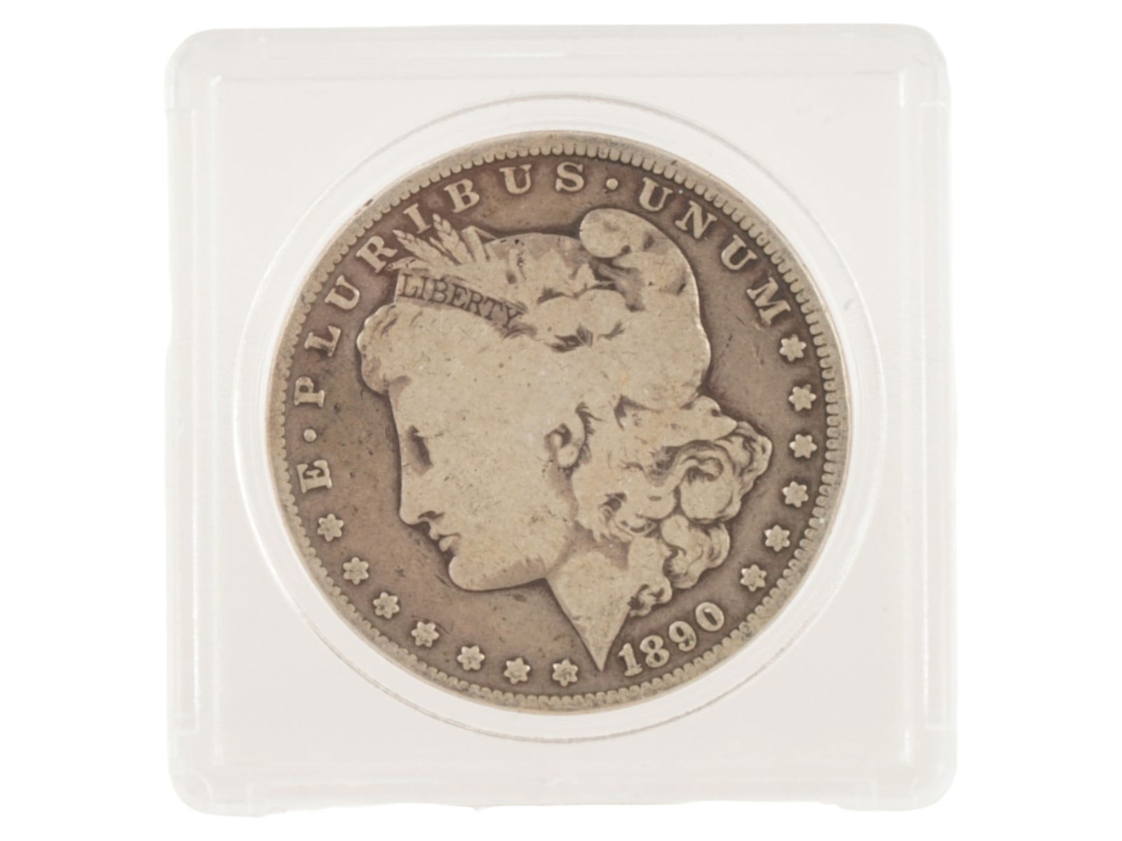 ANTIQUE 1890 AMERICAN CARSON CITY MORGAN SILVER DOLLAR: An antique 1890 American Carson City Morgan 90 percent silver dollar coin. CC DIRTY TONER. Named after its designer, George T. Morgan, this coin is one of the most iconic pieces of American coinage.