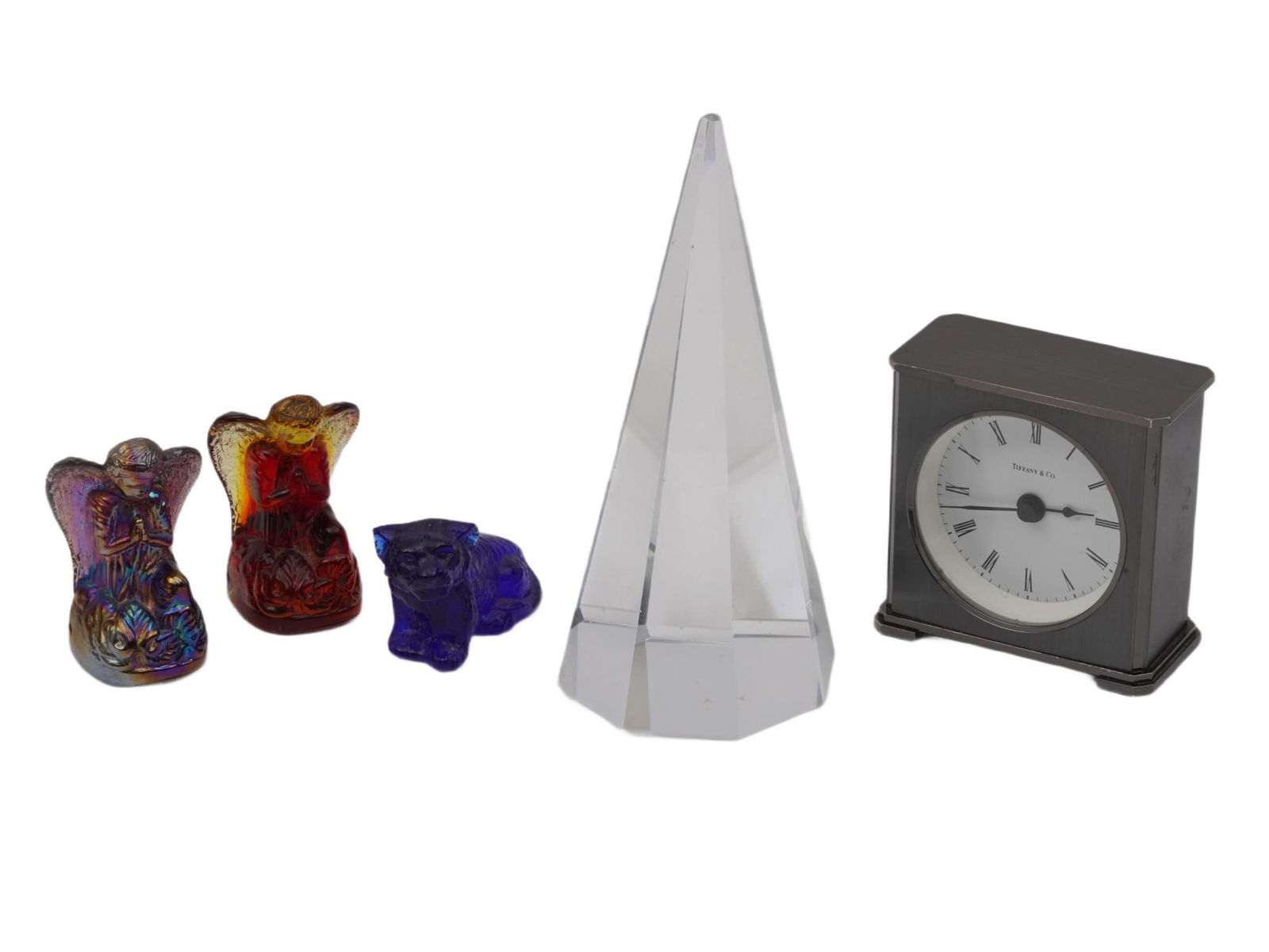 VTG TIFFANY CO CLOCK GLASS FIGURINES AND PYRAMID: A lot of five vintage assorted items. The lot contains a Tiffany and Co. table clock made in Germany in the 1970s, two iridescent glass praying angel figurines, and one tiger figurine. Also included i