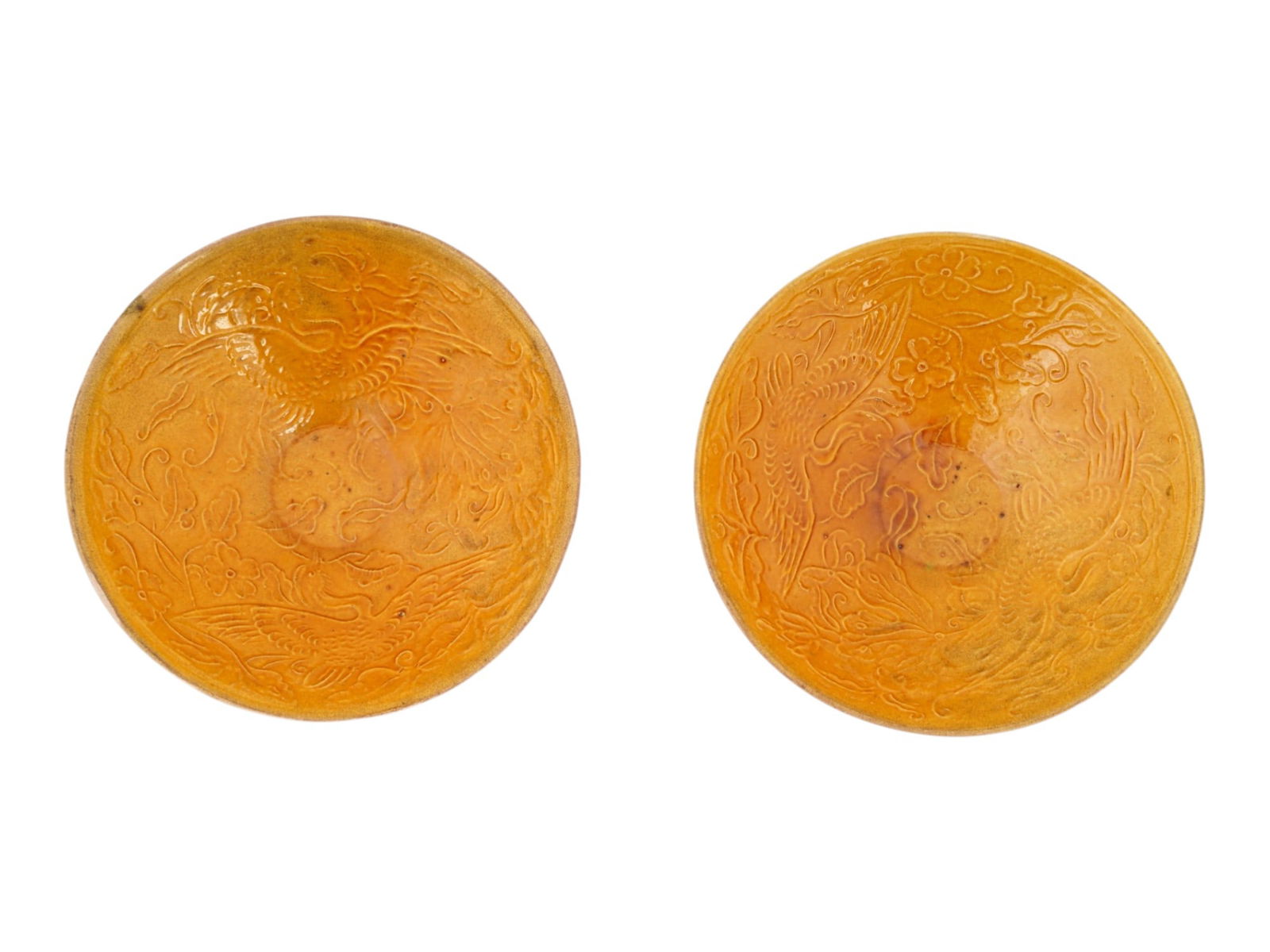 RARE PAIR OF CHINESE QING CERAMIC PHOENIX MOLDED BOWLS: A pair of Chinese Qing Dynasty conical form ceramic bowls. Covered with yellow glaze. The interior and exterior surfaces features engraved decoration depicting traditional Chinese motifs such as phoen