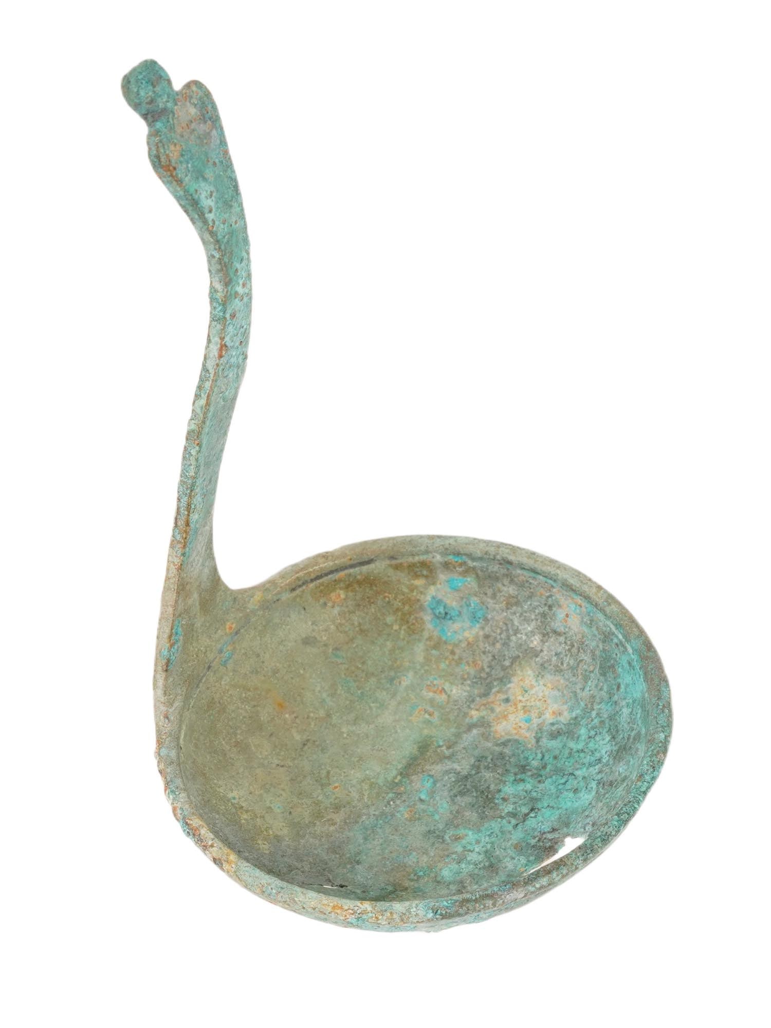 ANCIENT ROMAN BRONZE LADDLE W HANDLE 100 TO 300 AD: An ancient Roman bronze ladle. Circa: 100 to 300 AD. The ladle has a deep bowl and a vertical curved handle with a raised finial. Ancient Roman Bronze Table Wares, Historical Artifacts, Museum