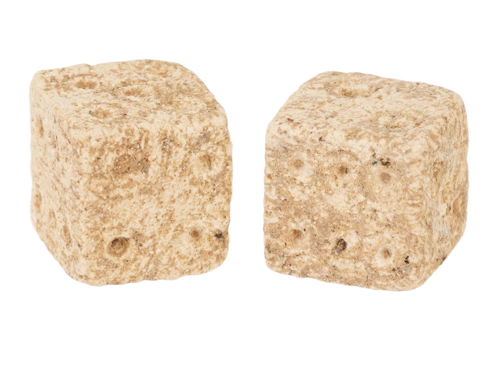 PAIR OF ANCIENT ROMAN STONE DICE 100 TO 300 AD: A pair of ancient Roman hand carved stone dice, dating from 100 to 300 AD. These artifacts offer a tangible connection to the everyday life and leisure activities of the past. Carved from stone