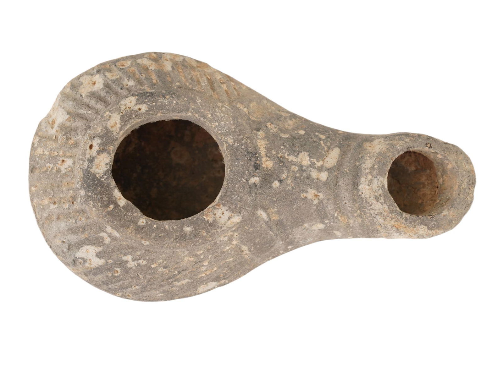 ANCIENT HELLENISTIC PERIOD EROTIC TERRACOTTA OIL LAMP: An ancient Hellenistic period terracotta oil lamp featuring an erotic design with a protruding nose. Decorated with a line pattern to the base. Circa: 300 to 100 BC. Made of unglazed clay. Historical