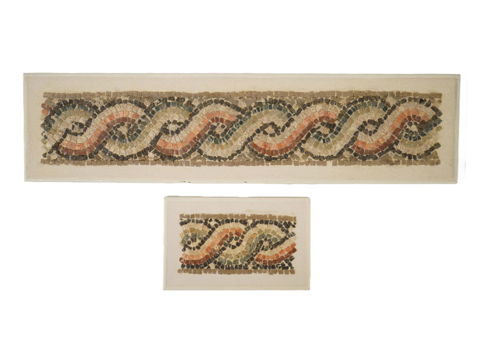 ANCIENT ROMAN FRAGMENT AND LOTUS MOSAICS 100 TO 300 AD: A lot of two ancient Roman mosaics. The lot includes a frame fragment featuring a decorative, wave-like or twisted pattern and a smaller piece depicting a lotus flower. Circa 100 to 300 AD. These arti