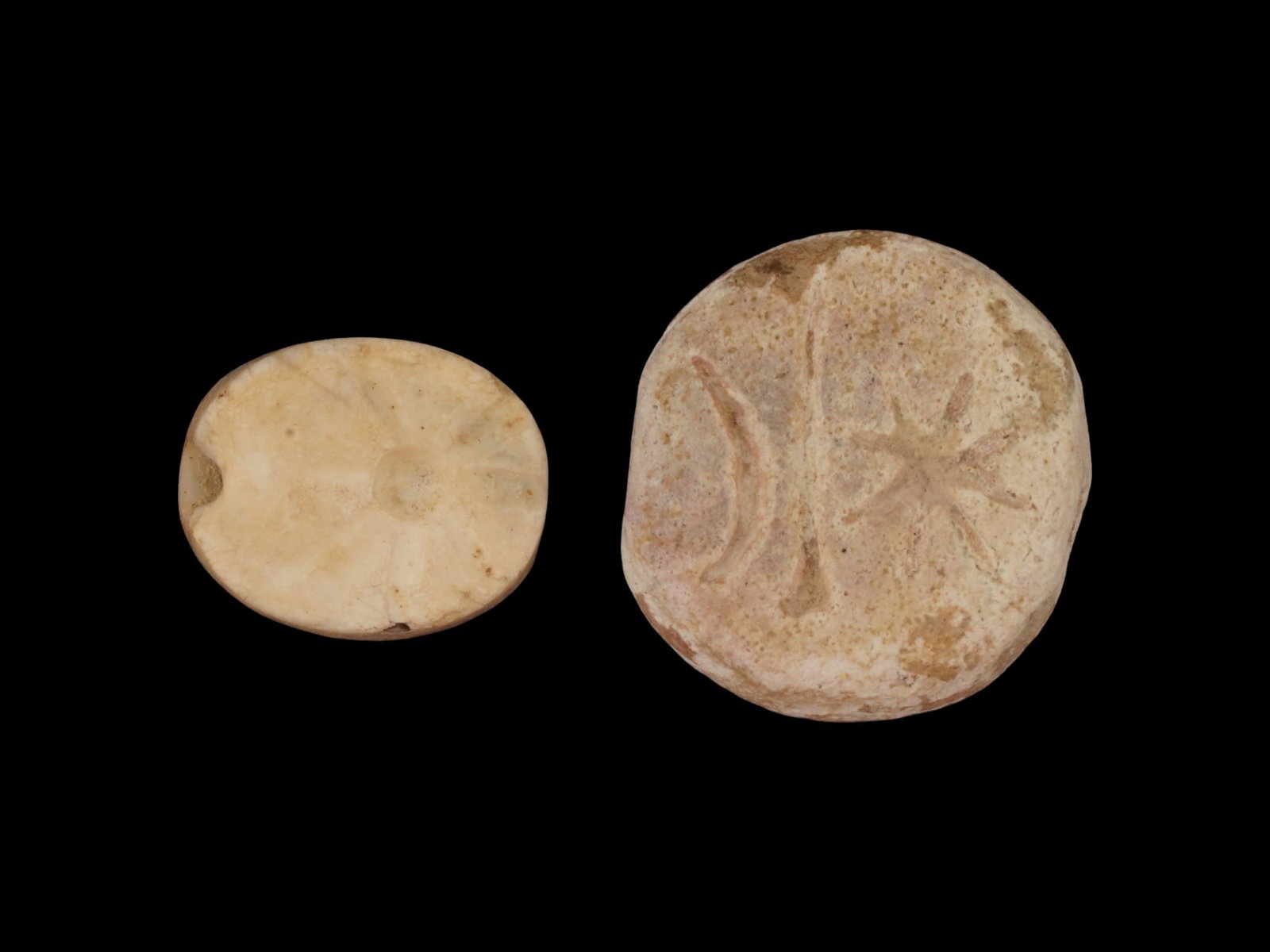 ANCIENT EGYPTIAN FAIENCE SCARAB AMULET BEADS: A lot of two ancient Egyptian faience scarab amulet beads. Oval and round pendants with a hole in the center, decorated with engraved images of the sun. Circa: 1st millenium BC. Collectible Historical