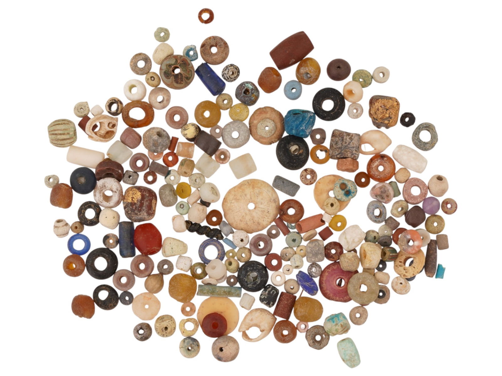 LARGE LOT OF ANCIENT EGYPTIAN MIXED GLASS STONE BEADS: A large collection of Ancient Egyptian beads made of glass, stone, carnelian, and faience. Late Period or Roman Egypt, ca. 700 to 100 BC. Various shapes. Historical Collectibles And Archaeological Rel