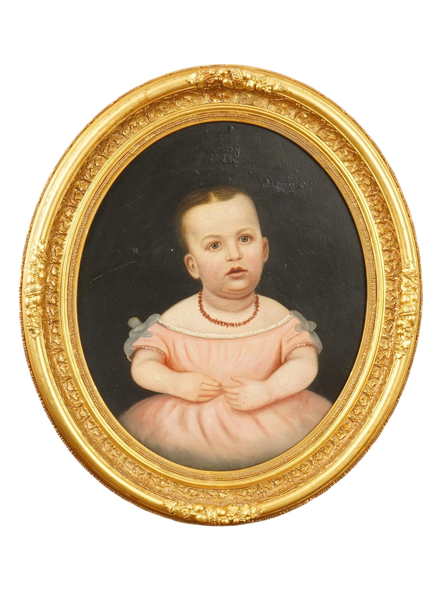 FINE ANTIQUE OVAL OIL PAINTING W 23K GOLD WOOD FRAME: A fine antique oil on board painting of oval shape. Depicting a portrait of a small girl in a pink dress. Circa 1860. Framed by a gilded 23K gold wooden frame. The frame is adorned with carved intrica