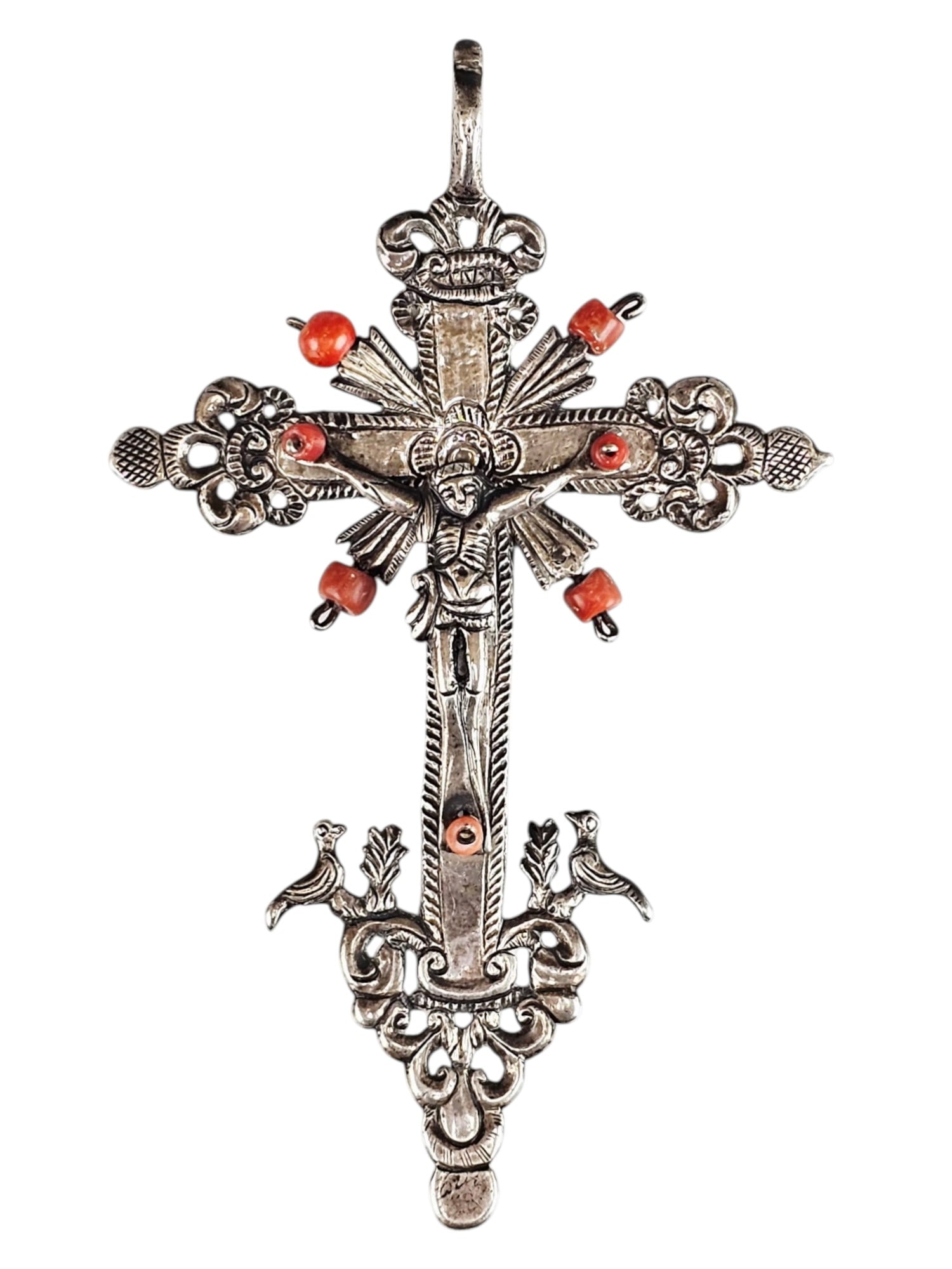 ANTIQUE ORNATE SILVER RELIGIOUS CROSS W RED CORAL BEADS: An antique ornate silver religious cross decorated with red coral beads. It features a detailed figure of Jesus at the center, set against a cross with radiating sunburst motifs and intricate scrolled