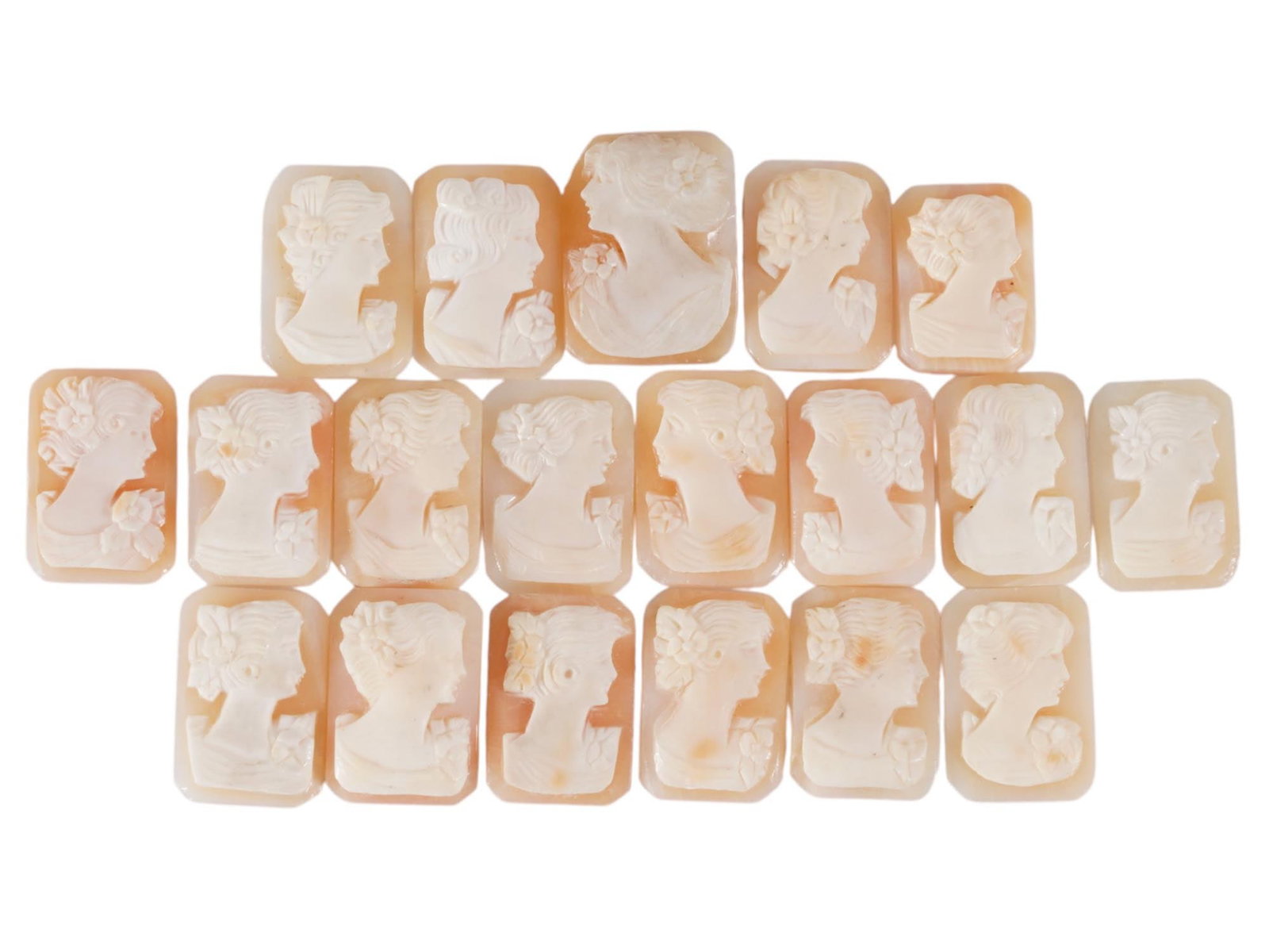 COLLECTION OF FEMALE PORTRAIT CARVED SHELL CAMEOS: A collection of hand carved shell cameos. A total of 19 items. Each piece depicts a female profile portrait rendered in high relief in the Victorian manner. Each cameo is fashioned in a distinctive oc