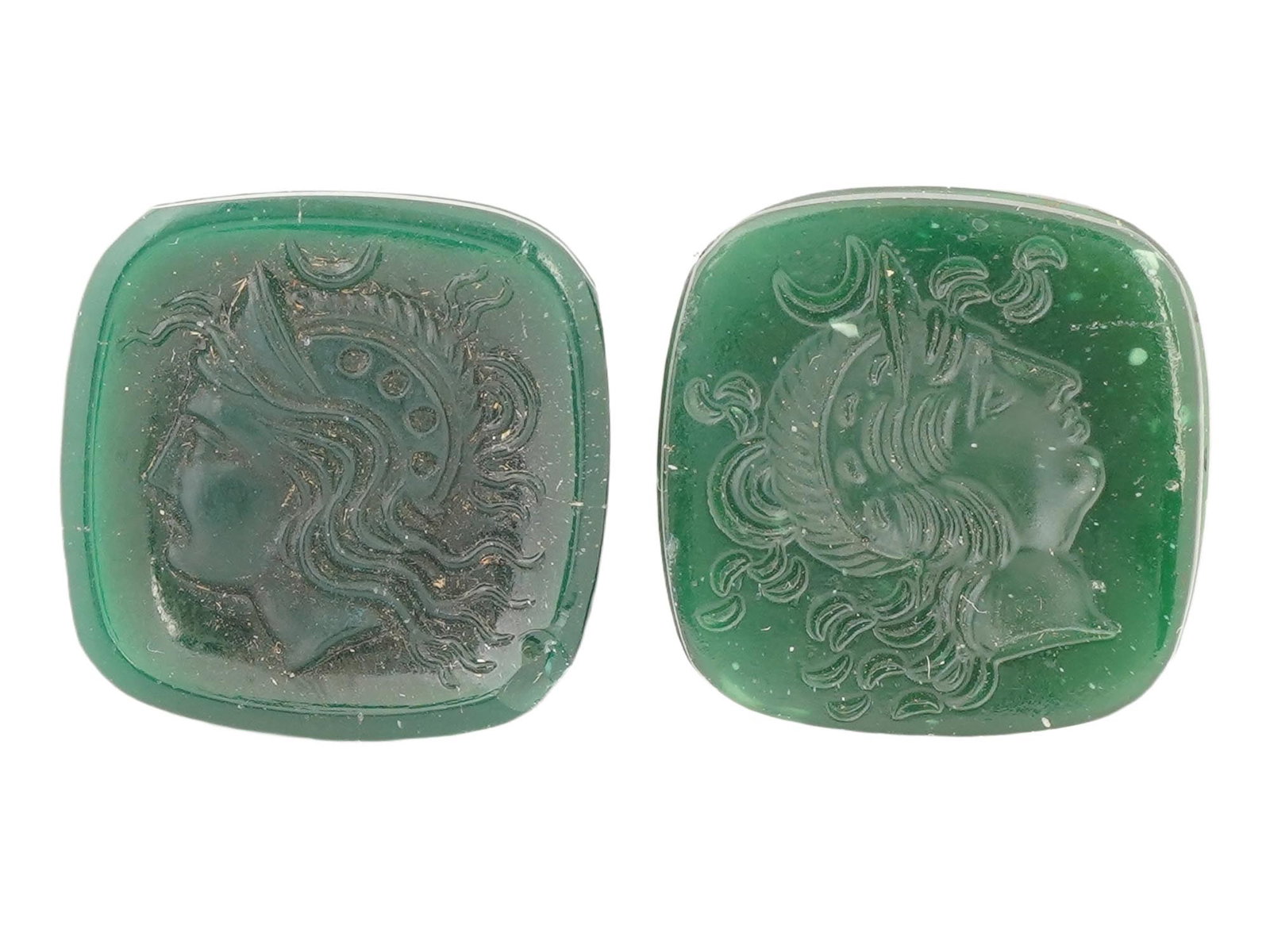 TWO ROMAN MANNER CARVED INTAGLIO CAMEOS FEMALE PROFILE: A lot of two carved intaglio cameos in a Roman manner. Each depicting a female profile, likely a goddess portrait. Green color and rectangular in shape. The reverse side is flat. Antique And