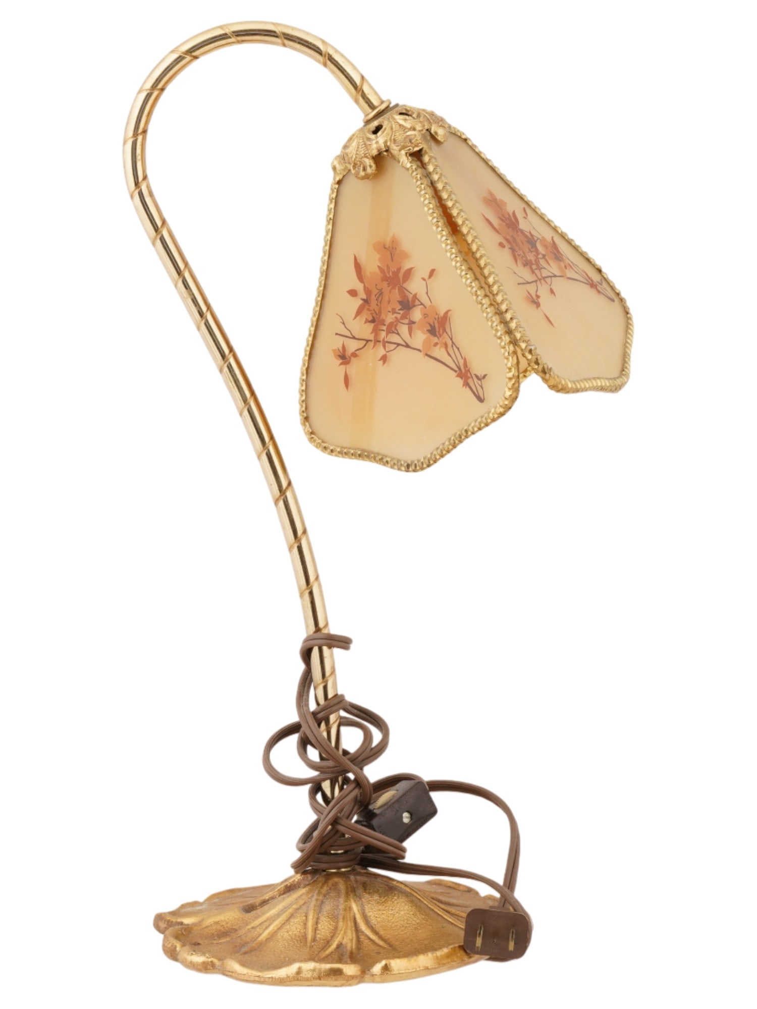 FLORAL FIGURAL DESIGN BRASS AND GLASS DESK LAMP: A vintage glass and brass desk lamp. The lamp features a curved brass neck, adorned with intricate detailing that mimics the natural floral designs. The glass shade is crafted in a charming floral sha