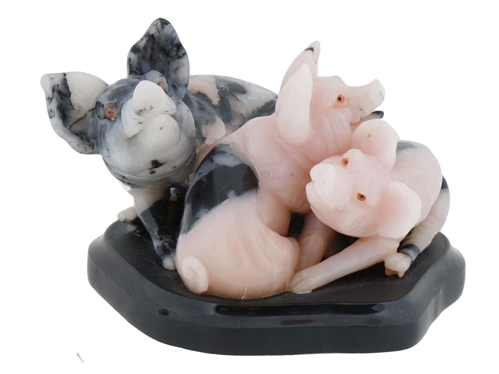 VINTAGE CARVED RHODONITE PIG FIGURINES ON A MARBLE BASE: A vintage carved sculpture features a composition of three pig figurines, rendered in vibrant pink rhodonite stone, resting on a contrasting marble base. The underside of the base is marked with BS,