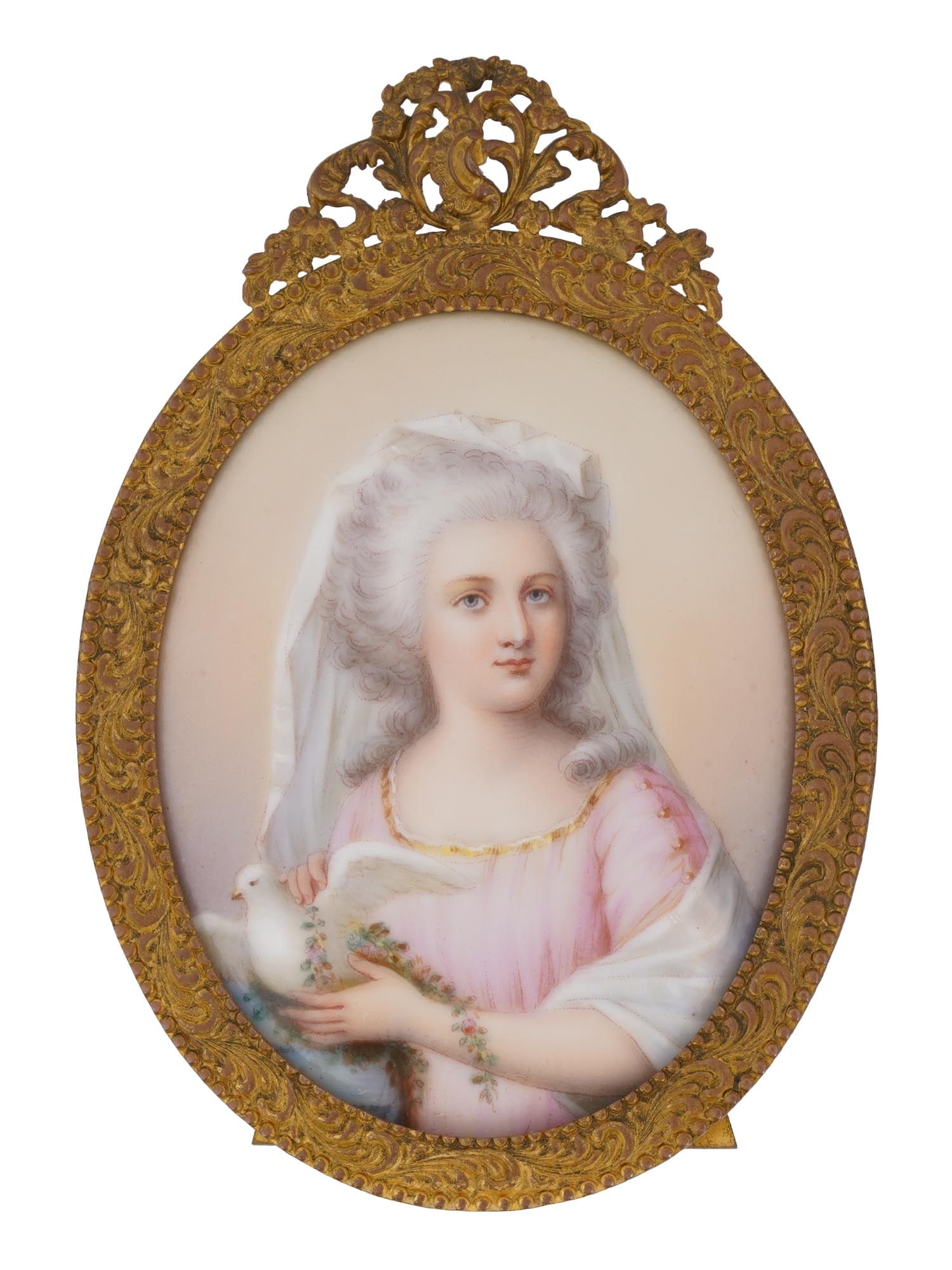 ANTIQUE EUROPEAN MINIATURE PAINTING ON PORCELAIN: An antique European miniature portrait painting on a porcelain plaque. The oval tabletop picture frame with a porcelain plaque depicting a finely detailed portrait of a young girl holding a white dove