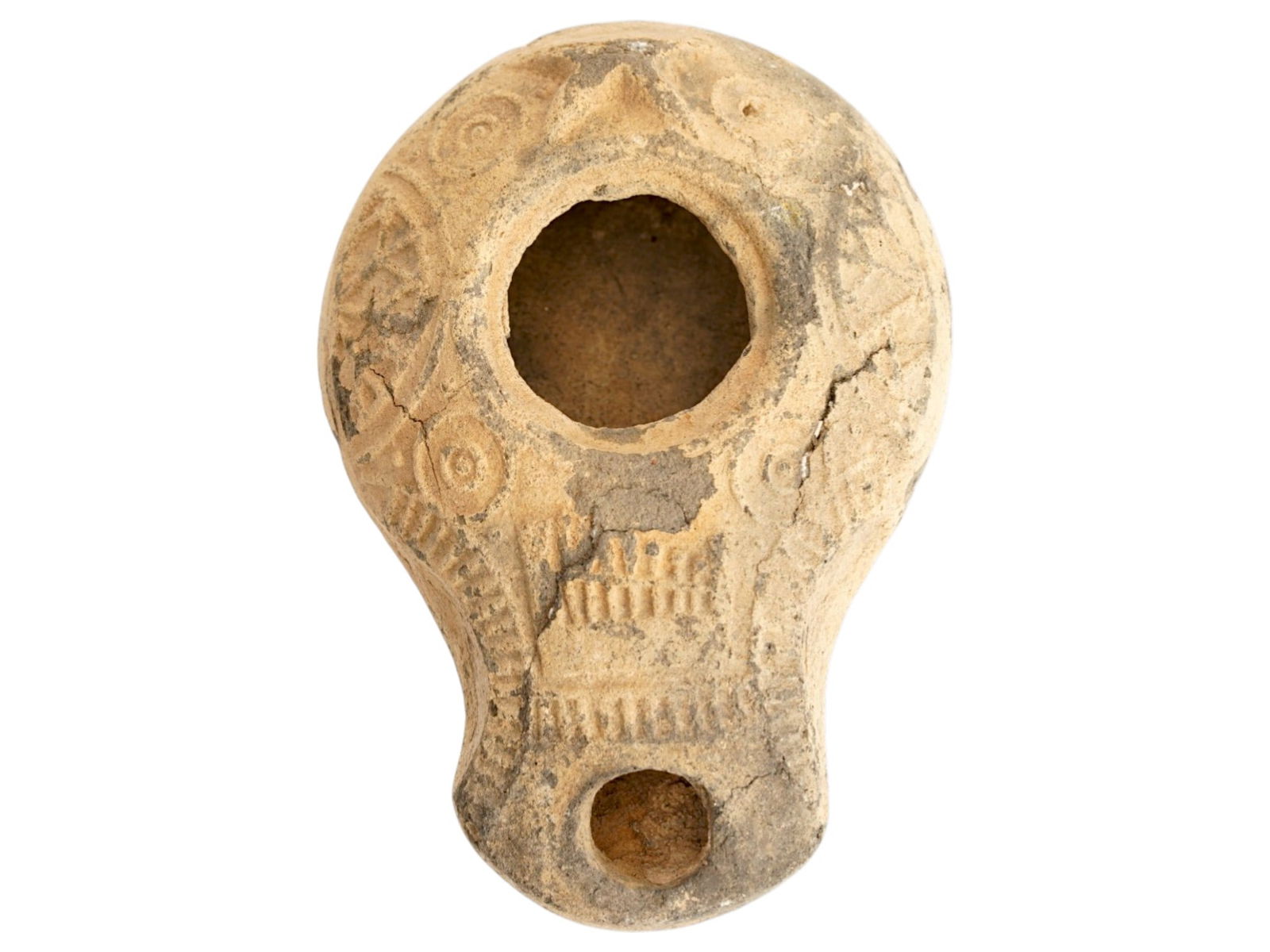 ANCIENT SAMARITAN JUDAICA TERRACOTTA POTTERY OIL LAMP: An ancient Samaritan Judaica moulded terracotta pottery oil lamp, known as a slipper lamp. The body of the lamp is hand painted and adorned with engraved ornaments. Its basic function was to provide l